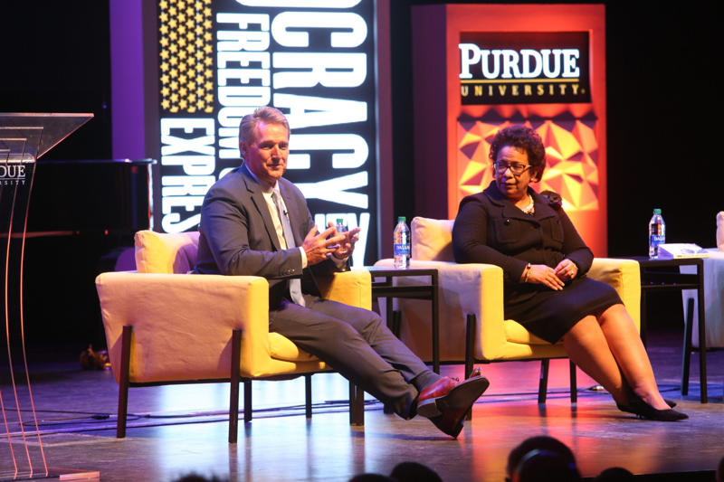 Jeff Flake and Loretta Lynch at Purdue University Deja Foxx on stage at Global Citizen NOW summit, Deja Foxx in Press Room at Jingle Ball 2021, Deja Foxx speaking at Moonpie event in Phoenix, Doug Emhoff greeted by local officials in Arizona, Adelita S. Grijalva at Lukeville Port conference, Deja Foxx and Chrissy Teigen take a selfie, Jeff Flake and Loretta Lynch at Purdue University