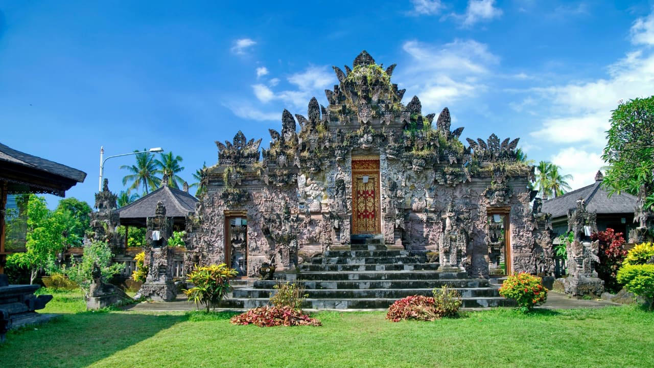 9. Pura Beji Sangsit: A Hidden Temple of Intricate Carvings Located in the village of Sangsit in North Bali, Pura Beji is a serene temple famed for its elaborate stone carvings and unique architectural style. Unlike the bustling temples near Ubud, it offers a peaceful atmosphere where visitors can appreciate Bali’s rich artistic heritage in quiet contemplation. What makes it unique: The temple’s detailed decorations and tranquil setting provide a glimpse into traditional Balinese craftsmanship away from tourist crowds. (Image: Canva) 1. Sidemen Valley: The Soul of Rural Bali Located in East Bali, Sidemen is a lush valley that feels like a time capsule. The region is framed by Mt. Agung, Bali’s sacred volcano, and layered with stunning rice terraces, bamboo forests, and sleepy villages. Hike through the fields, visit traditional weaving centers, or simply relax in a bamboo hut overlooking a river. It’s a favorite among yogis, writers, and slow travelers looking to escape the buzz of Ubud. Why go: Serene landscapes, fewer tourists, great base for cultural immersion and eco-friendly stays. (Image: Canva), 2. Nyang Nyang Beach: Bali’s Untamed Coastline One of the last untouched beaches in South Bali, Nyang Nyang demands effort—around 500 steps down a cliff—but rewards you with solitude, turquoise waves, and dramatic limestone backdrops. You won’t find sunbeds or bars here—just driftwood, wildflowers, and your own patch of sand. Tip: Go early in the morning to avoid the heat and enjoy the beach in silence. (Image: Canva), 3. Sangeh Monkey Forest: Tranquility Amidst Sacred Trees Tucked away in Badung Regency, Sangeh Monkey Forest is older and quieter than its more famous cousin in Ubud. The forest is home to towering nutmeg trees, Balinese temples, and a well-behaved tribe of macaques known for their less aggressive nature. It’s perfect for a quiet cultural detour. Insider fact: Locals believe the trees in the forest are sacred and spiritually protected. (Image: Canva), 4. Amed: A Diver’s Hideaway with a Laid-Back Vibe Amed’s coastline is worlds apart from Seminyak’s glitz. With its volcanic black-sand beaches, traditional jukung boats bobbing in the water, and easy access to coral reefs and WWII shipwrecks, it’s a paradise for snorkelers and divers. The pace is slow, the people warm, and the sunsets unforgettable. Don’t miss: Sunrise views of Mount Agung and a day trip to the Japanese shipwreck in Lipah Beach. (Image: Canva), 5. Munduk: Bali’s Misty Mountain Escape Set high in Bali’s northern highlands, Munduk is a tranquil village surrounded by coffee plantations, waterfalls, and dense forests. Cooler temperatures and misty mornings create a refreshing contrast to the island’s coast, inviting visitors to explore hiking trails and traditional villages far from the tourist bustle. Why it’s special: A peaceful retreat for nature lovers and trekkers seeking unspoiled landscapes and authentic local culture. (Image: Canva), 6. Penglipuran Village: Tradition Preserved in Harmony This Balinese Hindu village near Bangli is renowned for its commitment to preserving traditional architecture and customs. The village layout is based on the Tri Mandala concept—spatial zoning rooted in Balinese cosmology. It’s meticulously clean, with manicured gardens and bamboo forests at its edge. Why visit: Witness authentic Balinese culture and community-driven sustainability in action. (Image: Canva), 7. Banyu Wana Amertha Waterfall: A Hidden Natural Wonder Tucked away in the lush hills of Buleleng, this collection of waterfalls is lesser-known but absolutely spectacular. Multiple falls cascade through the jungle, offering secluded swimming spots and stunning photo opportunities. A short trek through flower farms and coffee plantations adds charm to the journey. Pro tip: Wear water shoes and bring a picnic for a truly immersive nature escape. (Image: Canva), 8. Menjangan Island: Bali’s Best Snorkeling Without the Crowds Situated in West Bali National Park, Menjangan Island is part of a protected marine reserve. The water clarity is exceptional, with vibrant coral walls, reef fish, and occasional sightings of reef sharks or turtles. On land, the island is home to wild deer that roam freely. Good to know: Access is by boat from Labuan Lalang; guided snorkel or dive trips can be arranged locally. (Image: Canva), 9. Pura Beji Sangsit: A Hidden Temple of Intricate Carvings Located in the village of Sangsit in North Bali, Pura Beji is a serene temple famed for its elaborate stone carvings and unique architectural style. Unlike the bustling temples near Ubud, it offers a peaceful atmosphere where visitors can appreciate Bali’s rich artistic heritage in quiet contemplation. What makes it unique: The temple’s detailed decorations and tranquil setting provide a glimpse into traditional Balinese craftsmanship away from tourist crowds. (Image: Canva)