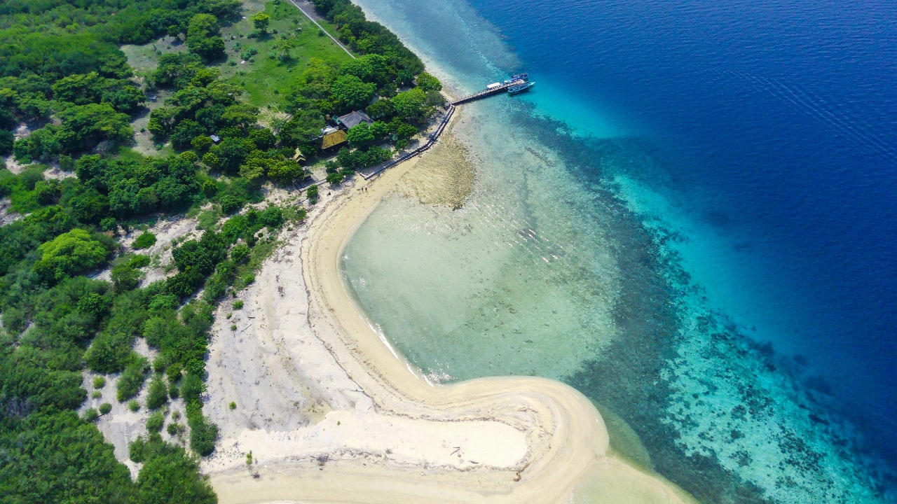 8. Menjangan Island: Bali’s Best Snorkeling Without the Crowds Situated in West Bali National Park, Menjangan Island is part of a protected marine reserve. The water clarity is exceptional, with vibrant coral walls, reef fish, and occasional sightings of reef sharks or turtles. On land, the island is home to wild deer that roam freely. Good to know: Access is by boat from Labuan Lalang; guided snorkel or dive trips can be arranged locally. (Image: Canva) 1. Sidemen Valley: The Soul of Rural Bali Located in East Bali, Sidemen is a lush valley that feels like a time capsule. The region is framed by Mt. Agung, Bali’s sacred volcano, and layered with stunning rice terraces, bamboo forests, and sleepy villages. Hike through the fields, visit traditional weaving centers, or simply relax in a bamboo hut overlooking a river. It’s a favorite among yogis, writers, and slow travelers looking to escape the buzz of Ubud. Why go: Serene landscapes, fewer tourists, great base for cultural immersion and eco-friendly stays. (Image: Canva), 2. Nyang Nyang Beach: Bali’s Untamed Coastline One of the last untouched beaches in South Bali, Nyang Nyang demands effort—around 500 steps down a cliff—but rewards you with solitude, turquoise waves, and dramatic limestone backdrops. You won’t find sunbeds or bars here—just driftwood, wildflowers, and your own patch of sand. Tip: Go early in the morning to avoid the heat and enjoy the beach in silence. (Image: Canva), 3. Sangeh Monkey Forest: Tranquility Amidst Sacred Trees Tucked away in Badung Regency, Sangeh Monkey Forest is older and quieter than its more famous cousin in Ubud. The forest is home to towering nutmeg trees, Balinese temples, and a well-behaved tribe of macaques known for their less aggressive nature. It’s perfect for a quiet cultural detour. Insider fact: Locals believe the trees in the forest are sacred and spiritually protected. (Image: Canva), 4. Amed: A Diver’s Hideaway with a Laid-Back Vibe Amed’s coastline is worlds apart from Seminyak’s glitz. With its volcanic black-sand beaches, traditional jukung boats bobbing in the water, and easy access to coral reefs and WWII shipwrecks, it’s a paradise for snorkelers and divers. The pace is slow, the people warm, and the sunsets unforgettable. Don’t miss: Sunrise views of Mount Agung and a day trip to the Japanese shipwreck in Lipah Beach. (Image: Canva), 5. Munduk: Bali’s Misty Mountain Escape Set high in Bali’s northern highlands, Munduk is a tranquil village surrounded by coffee plantations, waterfalls, and dense forests. Cooler temperatures and misty mornings create a refreshing contrast to the island’s coast, inviting visitors to explore hiking trails and traditional villages far from the tourist bustle. Why it’s special: A peaceful retreat for nature lovers and trekkers seeking unspoiled landscapes and authentic local culture. (Image: Canva), 6. Penglipuran Village: Tradition Preserved in Harmony This Balinese Hindu village near Bangli is renowned for its commitment to preserving traditional architecture and customs. The village layout is based on the Tri Mandala concept—spatial zoning rooted in Balinese cosmology. It’s meticulously clean, with manicured gardens and bamboo forests at its edge. Why visit: Witness authentic Balinese culture and community-driven sustainability in action. (Image: Canva), 7. Banyu Wana Amertha Waterfall: A Hidden Natural Wonder Tucked away in the lush hills of Buleleng, this collection of waterfalls is lesser-known but absolutely spectacular. Multiple falls cascade through the jungle, offering secluded swimming spots and stunning photo opportunities. A short trek through flower farms and coffee plantations adds charm to the journey. Pro tip: Wear water shoes and bring a picnic for a truly immersive nature escape. (Image: Canva), 8. Menjangan Island: Bali’s Best Snorkeling Without the Crowds Situated in West Bali National Park, Menjangan Island is part of a protected marine reserve. The water clarity is exceptional, with vibrant coral walls, reef fish, and occasional sightings of reef sharks or turtles. On land, the island is home to wild deer that roam freely. Good to know: Access is by boat from Labuan Lalang; guided snorkel or dive trips can be arranged locally. (Image: Canva), 9. Pura Beji Sangsit: A Hidden Temple of Intricate Carvings Located in the village of Sangsit in North Bali, Pura Beji is a serene temple famed for its elaborate stone carvings and unique architectural style. Unlike the bustling temples near Ubud, it offers a peaceful atmosphere where visitors can appreciate Bali’s rich artistic heritage in quiet contemplation. What makes it unique: The temple’s detailed decorations and tranquil setting provide a glimpse into traditional Balinese craftsmanship away from tourist crowds. (Image: Canva)