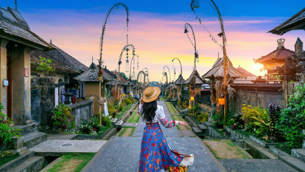 Bali is often painted in broad strokes—surf-packed beaches, lively beach clubs, bustling art markets, and centuries-old temples crawling with tourists. But beneath the surface of this well-traveled island lies a quieter, more spiritual Bali—where emerald valleys ripple with rice paddies, villages remain frozen in time, and coastal towns still hum with the rhythm of the tides rather than tourism. If you’re seeking authentic experiences away from the usual tourist traps, here are nine hidden gems in Bali that reveal the island’s lesser-known beauty and soul. (Image: Canva) 1. Sidemen Valley: The Soul of Rural Bali Located in East Bali, Sidemen is a lush valley that feels like a time capsule. The region is framed by Mt. Agung, Bali’s sacred volcano, and layered with stunning rice terraces, bamboo forests, and sleepy villages. Hike through the fields, visit traditional weaving centers, or simply relax in a bamboo hut overlooking a river. It’s a favorite among yogis, writers, and slow travelers looking to escape the buzz of Ubud. Why go: Serene landscapes, fewer tourists, great base for cultural immersion and eco-friendly stays. (Image: Canva), 2. Nyang Nyang Beach: Bali’s Untamed Coastline One of the last untouched beaches in South Bali, Nyang Nyang demands effort—around 500 steps down a cliff—but rewards you with solitude, turquoise waves, and dramatic limestone backdrops. You won’t find sunbeds or bars here—just driftwood, wildflowers, and your own patch of sand. Tip: Go early in the morning to avoid the heat and enjoy the beach in silence. (Image: Canva), 3. Sangeh Monkey Forest: Tranquility Amidst Sacred Trees Tucked away in Badung Regency, Sangeh Monkey Forest is older and quieter than its more famous cousin in Ubud. The forest is home to towering nutmeg trees, Balinese temples, and a well-behaved tribe of macaques known for their less aggressive nature. It’s perfect for a quiet cultural detour. Insider fact: Locals believe the trees in the forest are sacred and spiritually protected. (Image: Canva), 4. Amed: A Diver’s Hideaway with a Laid-Back Vibe Amed’s coastline is worlds apart from Seminyak’s glitz. With its volcanic black-sand beaches, traditional jukung boats bobbing in the water, and easy access to coral reefs and WWII shipwrecks, it’s a paradise for snorkelers and divers. The pace is slow, the people warm, and the sunsets unforgettable. Don’t miss: Sunrise views of Mount Agung and a day trip to the Japanese shipwreck in Lipah Beach. (Image: Canva), 5. Munduk: Bali’s Misty Mountain Escape Set high in Bali’s northern highlands, Munduk is a tranquil village surrounded by coffee plantations, waterfalls, and dense forests. Cooler temperatures and misty mornings create a refreshing contrast to the island’s coast, inviting visitors to explore hiking trails and traditional villages far from the tourist bustle. Why it’s special: A peaceful retreat for nature lovers and trekkers seeking unspoiled landscapes and authentic local culture. (Image: Canva), 6. Penglipuran Village: Tradition Preserved in Harmony This Balinese Hindu village near Bangli is renowned for its commitment to preserving traditional architecture and customs. The village layout is based on the Tri Mandala concept—spatial zoning rooted in Balinese cosmology. It’s meticulously clean, with manicured gardens and bamboo forests at its edge. Why visit: Witness authentic Balinese culture and community-driven sustainability in action. (Image: Canva), 7. Banyu Wana Amertha Waterfall: A Hidden Natural Wonder Tucked away in the lush hills of Buleleng, this collection of waterfalls is lesser-known but absolutely spectacular. Multiple falls cascade through the jungle, offering secluded swimming spots and stunning photo opportunities. A short trek through flower farms and coffee plantations adds charm to the journey. Pro tip: Wear water shoes and bring a picnic for a truly immersive nature escape. (Image: Canva), 8. Menjangan Island: Bali’s Best Snorkeling Without the Crowds Situated in West Bali National Park, Menjangan Island is part of a protected marine reserve. The water clarity is exceptional, with vibrant coral walls, reef fish, and occasional sightings of reef sharks or turtles. On land, the island is home to wild deer that roam freely. Good to know: Access is by boat from Labuan Lalang; guided snorkel or dive trips can be arranged locally. (Image: Canva), 9. Pura Beji Sangsit: A Hidden Temple of Intricate Carvings Located in the village of Sangsit in North Bali, Pura Beji is a serene temple famed for its elaborate stone carvings and unique architectural style. Unlike the bustling temples near Ubud, it offers a peaceful atmosphere where visitors can appreciate Bali’s rich artistic heritage in quiet contemplation. What makes it unique: The temple’s detailed decorations and tranquil setting provide a glimpse into traditional Balinese craftsmanship away from tourist crowds. (Image: Canva)