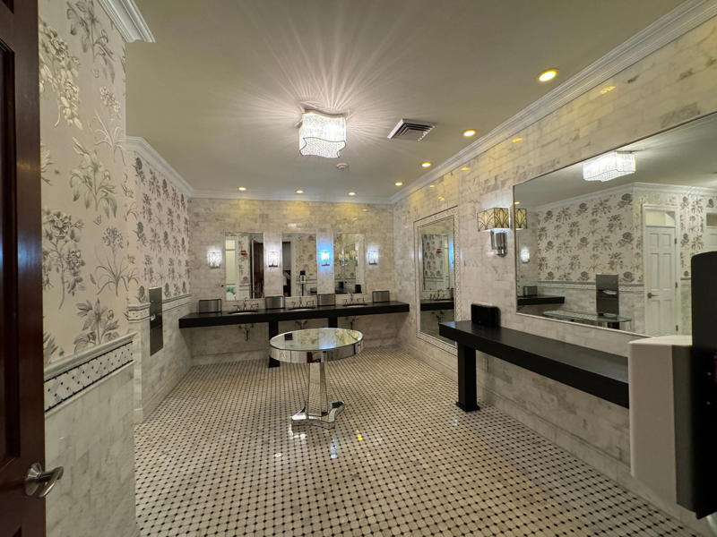 This bathroom has been converted, but it used to be the servants' dining room. It also features the largest fireplace in the home., The billiards room also has a luxurious window seat., Directly next to the breakfast room was another wood-paneled study., It has yet another perfect window seat., It's also one of the only rooms with a private bathroom., We stopped at one more guest room, which was more modest., As the tour concluded, we were able to explore the gardens outside.