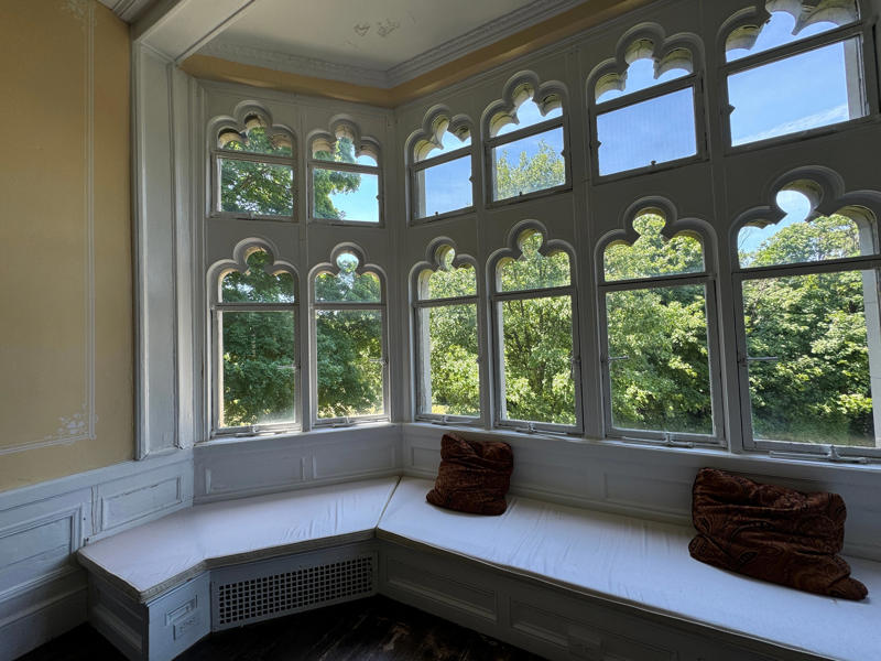 It has yet another perfect window seat. It also features the largest fireplace in the home., The billiards room also has a luxurious window seat., Directly next to the breakfast room was another wood-paneled study., It has yet another perfect window seat., It's also one of the only rooms with a private bathroom., We stopped at one more guest room, which was more modest., As the tour concluded, we were able to explore the gardens outside.