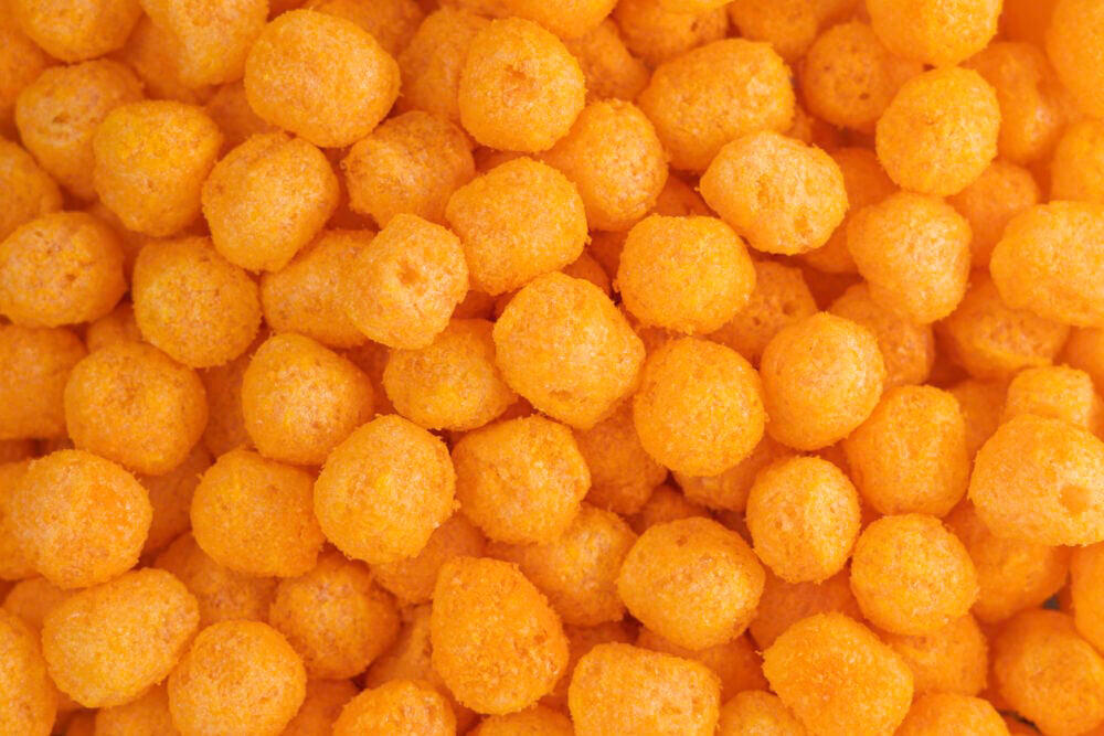1. Dunkaroos were the gold standard of lunchbox clout., 2. Hi-C Ecto Cooler meant your fridge was practically glowing., 3. Pizzarias chips were basically pizza in a bag., 4. Planters Cheez Balls turned orange fingers into a badge of honor., 5. Oreo O’s made cereal feel like dessert before school., 6. Squeezit drinks turned hydration into a color war., 7. Fruit String Thing was edible art on a plastic tray., 8. PB Crisps made peanuts feel like treasure., 9. Magic Middles were cookies with a buttery secret., 10. Reggie! Bars made baseball edible and indulgent.
