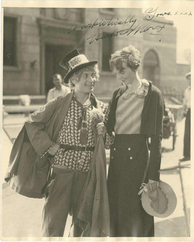 12. Harpo Marx and Amelia Earhart on the set of Horse Feathers, 1932 1. A World War Veteran, 1932, 2. Jean Bugatti standing next to his Bugatti Royale, one of the seven he built, 1932, 3. This milkmaid is trying to get the pig off the road, Norway, 1932, 4. Joan Crawford, 1932, 5. Just a young girl and her dog, 1932, 6. Taking a break after their tennis match, Washington DC, 1932, 7. Charles Ebbets shooting his famous photo, Lunch atop a Skyscraper, 1932, 8. Rocking the fur coats and a Cadillac in Harlem, 1932, 9. Painting the Eiffel Tower in 1932, 10. Sitting in peace in NYC, 1932, 11. Driving a dynasphere, 1932, 12. Harpo Marx and Amelia Earhart on the set of Horse Feathers, 1932, 13. Jacob Rheuben Ehrlich (8 ft 6 in) walking the Chicago streets with kids, 1932, 14. Sitting on a truck, playing her guitar in Amarillo, Texas, 1932, 15. A family portrait in Poland, 1932, 16. A colorized portrait of Amelia Earhart, 1932, 17. A woman bringing her pet cat to have a cup of tea, 18. Charles C. Ebbets snapping photos on a skyscraper, 1932, 19. Young Love, 1932, 20. Stan Laurel and Oliver Hardy taking a break from filming, 1932, 21. Fighting their way through the snow, 1932, 22. Taking an extremely unsafe nap, 1932, 23. Street fashion in Japan, 1932, 24. This is what packing for a camping trip looked like in 1932