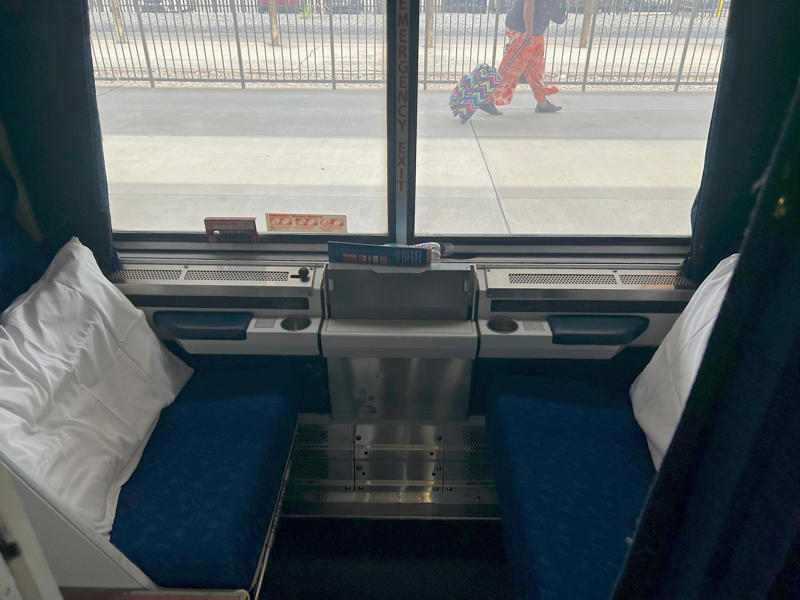 Unfortunately, my first-class journey began with a five-hour delay., Once my train finally arrived, I got to board early., A dedicated attendant guided me down the slim walkways to my room., The upper level featured a comfortable bed., The upper bed had its own storage space and viewing window., The dining car felt like a fine-dining experience ..., After a long day, the bed in the roomette was a godsend., Finally, I arrived at my destination six hours after the scheduled time.