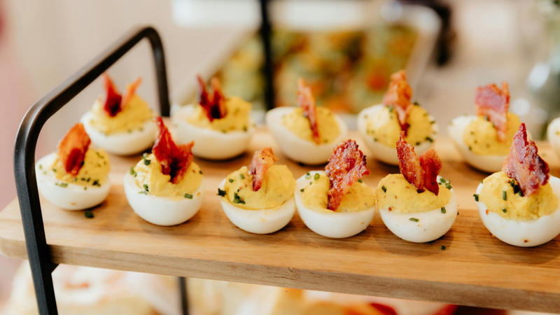 1. Melon Prosciutto Skewers, 2. Pinwheel Sandwiches, 3. Grilled Tomatoes, 4. Stuffed Jalapeños, 5. Caprese Salad, 6. Meatball Parmesan Skewers, 7. Peach Crostini, 8. Stuffed Mushrooms, 9. Guacamole, 10. Prosciutto Wrapped Asparagus, 11. Tomato Bruschetta, 12. Deviled Eggs, 13. Coconut Shrimp, 14. Pigs in a Blanket, 15. Everything Bagel Dip With Veggies, 16. Carrot and Cheddar Bites, 17. Hummus, 18. Texas Caviar, 19. Watermelon Feta Skewers, 20. Garlic Lemon Scallops
