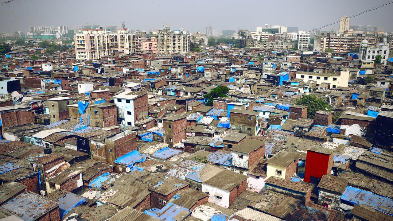 9. Dharavi, Mumbai, India Spanning less than a square mile, Dharavi houses close to a million people, making it one of the most densely packed urban areas on Earth. Narrow alleys, unregulated electricity, and poor sanitation foster conditions ripe for fire, flood, and disease. Despite its challenges, Dharavi is also an economic engine—home to thousands of micro-industries producing textiles, pottery, and recycled goods worth over a billion dollars annually. (Image: Canva) 2. La Rinconada, Peru Perched at nearly 17,000 feet above sea level, La Rinconada is the highest permanent settlement on Earth. The thin atmosphere makes every breath laborious, while year-round sub-zero temperatures render daily tasks arduous. Its unregulated gold mines attract thousands despite the absence of basic infrastructure. Mercury contamination, lack of sanitation, and oxygen deprivation are part of daily life in this mountain outpost often described as purgatory on Earth. (Image: Wikipedia), 3. Yakutsk, Russia Situated deep in Siberia, Yakutsk is the coldest major city in the world. Winter temperatures routinely plunge below -40°C, freezing skin in mere moments. Homes are built on stilts to avoid melting the permafrost, and vehicles must be kept running to prevent their engines from freezing solid. Yet, over 340,000 people call it home, adapting with ingenuity and endurance to an environment that offers neither forgiveness nor reprieve. (Image: Canva), 4. Norilsk, Russia Locked behind the Arctic Circle, Norilsk is both remote and toxic. Established as a mining town, it suffers from some of the world’s worst industrial pollution. Residents breathe in sulfur-laced air while black snow falls during winter. The city endures a 45-day polar night, and the landscape within a 30-mile radius is barren due to acid rain. It remains a closed city, inaccessible without official permission. (Image: Canva), 5. Dallol, Ethiopia Dallol, located in the Danakil Depression, holds the record for the highest average annual temperature ever recorded. With its sulphuric pools, neon mineral crusts, and geysers of toxic steam, it resembles a science fiction set more than a human habitat. Though now uninhabited, nomads and salt miners still pass through, navigating an area where rainfall is virtually nonexistent and the air can scald. (Image: Canva), 6. Ittoqqortoormiit, Greenland Remote and ice-bound for much of the year, this settlement is a study in isolation. Home to roughly 350 people, it can only be reached by helicopter or boat during brief windows of accessibility. Winter darkness lasts for months, temperatures plummet, and polar bears pose a very real threat. Emergency evacuations are perilous, and the nearest neighbouring town is 300 miles away. (Image: Canva), 8. Chernobyl, Ukraine Within the Chernobyl Exclusion Zone, a small number of elderly inhabitants defy radiation and time. After the 1986 meltdown, most fled. Some, however, returned to reclaim their homes, despite radiation levels still far exceeding safety norms. These residents live without running water or medical care, growing food in contaminated soil. Their lives carry the quiet defiance of those who have outlived disaster. (Image: Canva), 9. Dharavi, Mumbai, India Spanning less than a square mile, Dharavi houses close to a million people, making it one of the most densely packed urban areas on Earth. Narrow alleys, unregulated electricity, and poor sanitation foster conditions ripe for fire, flood, and disease. Despite its challenges, Dharavi is also an economic engine—home to thousands of micro-industries producing textiles, pottery, and recycled goods worth over a billion dollars annually. (Image: Canva), 10. Villa Las Estrellas, Antarctica Located on King George Island, this Chilean settlement resembles a scientific outpost more than a town. Long-term residents must undergo appendectomies before arriving, as medical facilities are rudimentary and evacuations impossible in winter. Here, families endure endless nights, hurricane-force winds, and frigid temperatures, living in prefabricated homes amid one of Earth’s most hostile environments. (Image: Wikipedia), 11. Barrow (Utqiaġvik), Alaska, USA The northernmost city in the United States lives in the shadow of disappearing coastlines and encroaching darkness. Barrow experiences more than two months without sunlight each winter. Supply chains are fragile, with most goods arriving by air. Climate change has turned the surrounding permafrost into sinking land, while sea ice retreats leave it more exposed to erosion. Yet life here persists—rugged, quiet, and enduring. (Image: Canva)