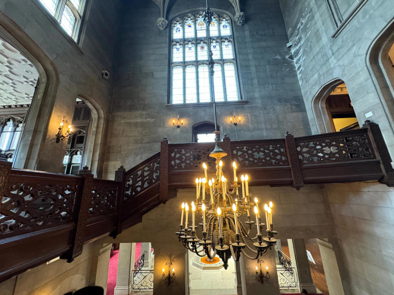 We then headed upstairs, giving us another view of the impressive tower and chandelier. It also features the largest fireplace in the home., The billiards room also has a luxurious window seat., Directly next to the breakfast room was another wood-paneled study., It has yet another perfect window seat., It's also one of the only rooms with a private bathroom., We stopped at one more guest room, which was more modest., As the tour concluded, we were able to explore the gardens outside.