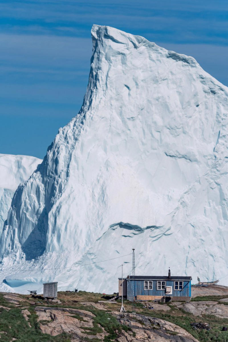 Incredible photos show huge iceberg drifting dangerously close to shore