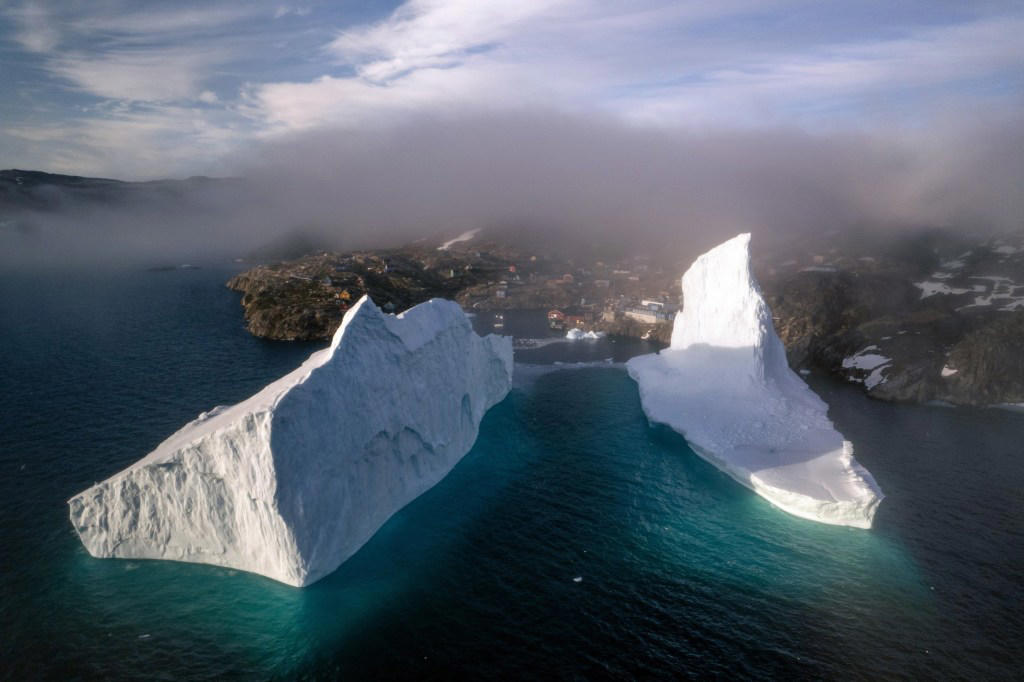 Incredible photos show huge iceberg drifting dangerously close to shore