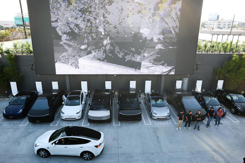 The Tesla Diner is in West Hollywood, California., Wallpaper inside the restaurant broadcasts Tesla's mission to diners., The diner's website says it has 80 Supercharger stalls., Besides the food and charging access, it's also part drive-in movie theater.