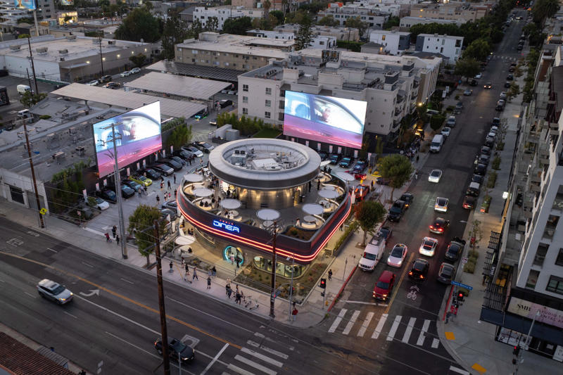 The Tesla Diner is in West Hollywood, California., Wallpaper inside the restaurant broadcasts Tesla's mission to diners., The diner's website says it has 80 Supercharger stalls., Besides the food and charging access, it's also part drive-in movie theater.