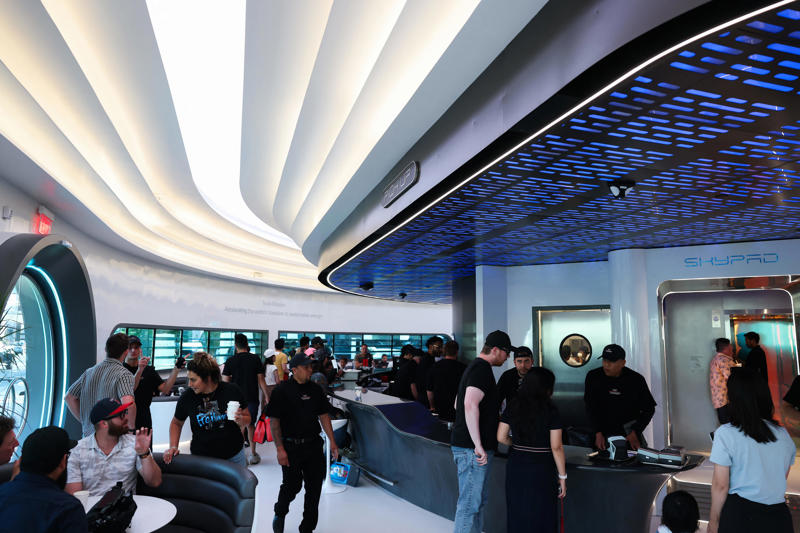 The Tesla Diner is in West Hollywood, California., Wallpaper inside the restaurant broadcasts Tesla's mission to diners., The diner's website says it has 80 Supercharger stalls., Besides the food and charging access, it's also part drive-in movie theater.