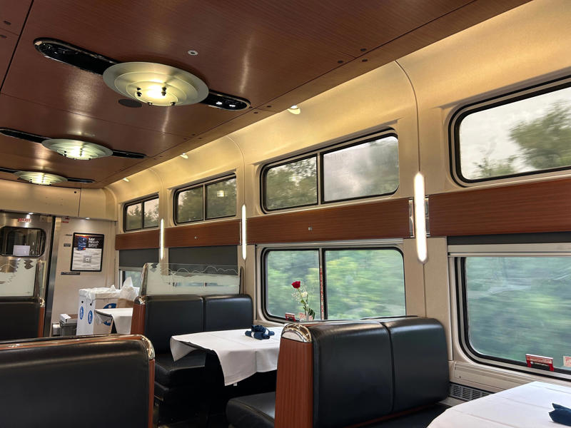 Unfortunately, my first-class journey began with a five-hour delay., Once my train finally arrived, I got to board early., A dedicated attendant guided me down the slim walkways to my room., The upper level featured a comfortable bed., The upper bed had its own storage space and viewing window., The dining car felt like a fine-dining experience ..., After a long day, the bed in the roomette was a godsend., Finally, I arrived at my destination six hours after the scheduled time.