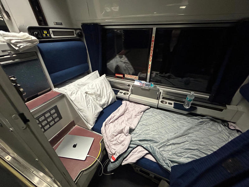 Unfortunately, my first-class journey began with a five-hour delay., Once my train finally arrived, I got to board early., A dedicated attendant guided me down the slim walkways to my room., The upper level featured a comfortable bed., The upper bed had its own storage space and viewing window., The dining car felt like a fine-dining experience ..., After a long day, the bed in the roomette was a godsend., Finally, I arrived at my destination six hours after the scheduled time.