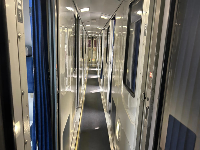 Unfortunately, my first-class journey began with a five-hour delay., Once my train finally arrived, I got to board early., A dedicated attendant guided me down the slim walkways to my room., The upper level featured a comfortable bed., The upper bed had its own storage space and viewing window., The dining car felt like a fine-dining experience ..., After a long day, the bed in the roomette was a godsend., Finally, I arrived at my destination six hours after the scheduled time.