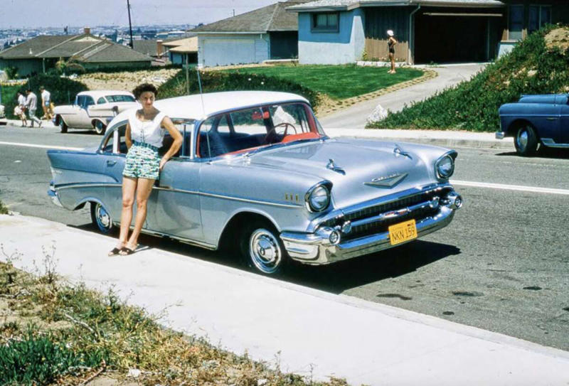 32. Hanging out with a new car in a new subdivision, late 1950s 1. Fans watching the new 1958 Los Angeles Dodgers, 2. A 1958 Chevrolet Imapala, 3. A solid Saturday afternoon matinee by the looks of it, circa 1958, 4. A couple young ladies waiting around in the benches, dressed their best, 1958, 5. Someone's family on a road trip, Kodachrome, 1958, 6. Scotch & Pretzels, 1958, 7. A proud owner of a new 1958 Oldsmobile, 8. A diner somewhere in America, 1958, 9. The Miami International Airport, 1958, 10. The front seat of a 1958 Buick, 11. Party at grandma's house, 1958, 12. Sellers of bread, Athens, Greece, 1958, 13. 1958, Oswego, New York, 14. A wonderful snapshot of the San Francisco street scene, 1958, 15. Pele, Sweden, 1958, 16. Canal Street, New Orleans, Louisiana, 1958, 17. Knott's Berry Farm, late 1950s, 18. A quick stop for breakfast for a long ole drive around, late 1950s, 19. Niagara Falls, 1958, 20. Dearborn, Michigan, Fire Department, 21. Kids playing ball in the street, 1958, 22. Christmastime in downtown Marion, Indiana, 1958, 23. A rainy day in Downtown, Indianapolis, Indiana, 24. Rochester, New York, 1958, 25. The Brussels International Airport, 1958, 26. People at the popular holiday resort of Capri, Italy, 1958, 27. A frosty day in February, 1958, 28. Listening to music in art class back in 1957, 29. Open-air schools in Netherlands in 1957, 30. Bill showing off his model aircraft collection in the late 1950s, 31. A high school football game in 1957, 32. Hanging out with a new car in a new subdivision, late 1950s, 33. A couple kids dreaming after grabbing a couple new toys in the late 1950s, 34. Getting dropped for naval flight training in 1957