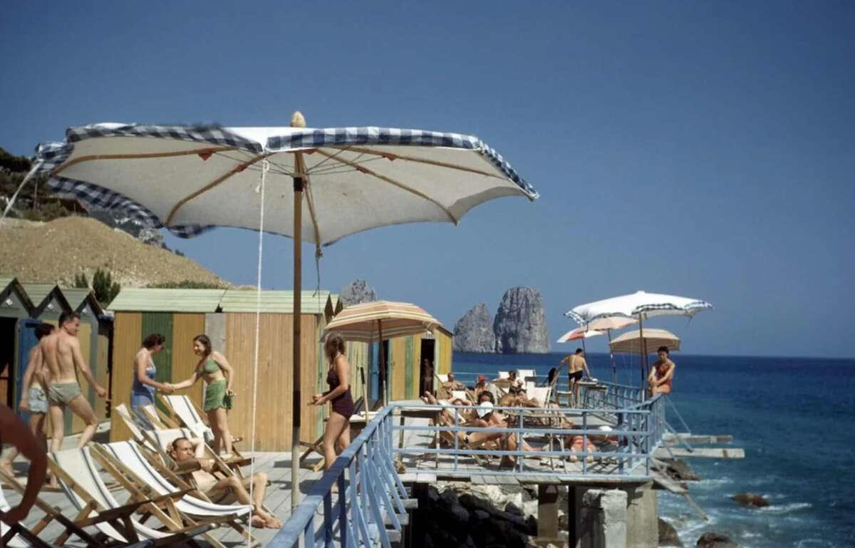 26. People at the popular holiday resort of Capri, Italy, 1958 1. Fans watching the new 1958 Los Angeles Dodgers, 2. A 1958 Chevrolet Imapala, 3. A solid Saturday afternoon matinee by the looks of it, circa 1958, 4. A couple young ladies waiting around in the benches, dressed their best, 1958, 5. Someone's family on a road trip, Kodachrome, 1958, 6. Scotch & Pretzels, 1958, 7. A proud owner of a new 1958 Oldsmobile, 8. A diner somewhere in America, 1958, 9. The Miami International Airport, 1958, 10. The front seat of a 1958 Buick, 11. Party at grandma's house, 1958, 12. Sellers of bread, Athens, Greece, 1958, 13. 1958, Oswego, New York, 14. A wonderful snapshot of the San Francisco street scene, 1958, 15. Pele, Sweden, 1958, 16. Canal Street, New Orleans, Louisiana, 1958, 17. Knott's Berry Farm, late 1950s, 18. A quick stop for breakfast for a long ole drive around, late 1950s, 19. Niagara Falls, 1958, 20. Dearborn, Michigan, Fire Department, 21. Kids playing ball in the street, 1958, 22. Christmastime in downtown Marion, Indiana, 1958, 23. A rainy day in Downtown, Indianapolis, Indiana, 24. Rochester, New York, 1958, 25. The Brussels International Airport, 1958, 26. People at the popular holiday resort of Capri, Italy, 1958, 27. A frosty day in February, 1958, 28. Listening to music in art class back in 1957, 29. Open-air schools in Netherlands in 1957, 30. Bill showing off his model aircraft collection in the late 1950s, 31. A high school football game in 1957, 32. Hanging out with a new car in a new subdivision, late 1950s, 33. A couple kids dreaming after grabbing a couple new toys in the late 1950s, 34. Getting dropped for naval flight training in 1957