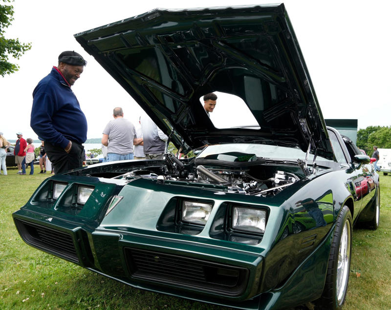 Father and grandson admire a vintage Pontiac Trans Am Father and grandson admire a vintage Pontiac Trans Am, Mary Barra speaks at Automotive Press Association event, Biden tours Corvette Z06 at auto show, Mary Barra addresses journalists at fireside chat, GM CEO Mary Barra with WDIV-TV anchors, General Motors vehicles in Renaissance Center, Ambetter 400 pace car at Atlanta Motor Speedway, Construction at General Motors Spring Hill plant
