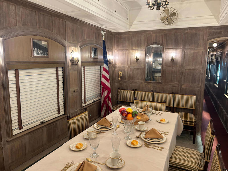 The dining and conference room was in the main cabin of the car. To carry the president, the unique armored car had enhanced security features., In the kitchen, an onboard chef had access to ovens and refrigerators., The car housed two staff members: a chef and a porter., The car included two guest bedrooms along with a presidential suite., The presidential suite included the president's sleeping area., The first lady's room was located parallel to the president's., A narrow hallway led from the staterooms to the observation deck., The observation lounge featured some of the presidential car's original furniture., During the refurbishment, a submarine escape hatch was added to the car.