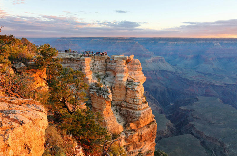 1. Ride the train to the South Rim via Grand Canyon Railway, 2. Absorb the canyon’s majesty from several viewpoints, 3. Admire landscape-inspired art at Kolb Studio, 4. Take a hike along Bright Angel Trail or South Kaibab Trail, 5. Check into Phantom Ranch or another woodsy in-park lodge, 6. Kayak curvy Horseshoe Bend, 7. Go white-water rafting on the Colorado River, 8. Take in layered vistas with a bike ride along the South Rim Trail, 9. Don’t forget a North Rim excursion, 10. Explore the East Entrance and Desert View Watchtower, 11. Admire the view from Roosevelt Point, 12. Embark on a mule trip to the bottom of the canyon, 13. Visit the Trail of Time for a geologic journey, 14. Tour the East Cabin at Pipe Spring National Monument, 15. Marvel at the night sky, 16. Step back in time at Bright Angel Lodge, 17. Walk the edge of the Skywalk, 18. Soar high on a scenic helicopter tour