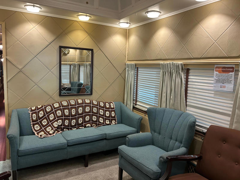 The observation lounge featured some of the presidential car's original furniture. To carry the president, the unique armored car had enhanced security features., In the kitchen, an onboard chef had access to ovens and refrigerators., The car housed two staff members: a chef and a porter., The car included two guest bedrooms along with a presidential suite., The presidential suite included the president's sleeping area., The first lady's room was located parallel to the president's., A narrow hallway led from the staterooms to the observation deck., The observation lounge featured some of the presidential car's original furniture., During the refurbishment, a submarine escape hatch was added to the car.