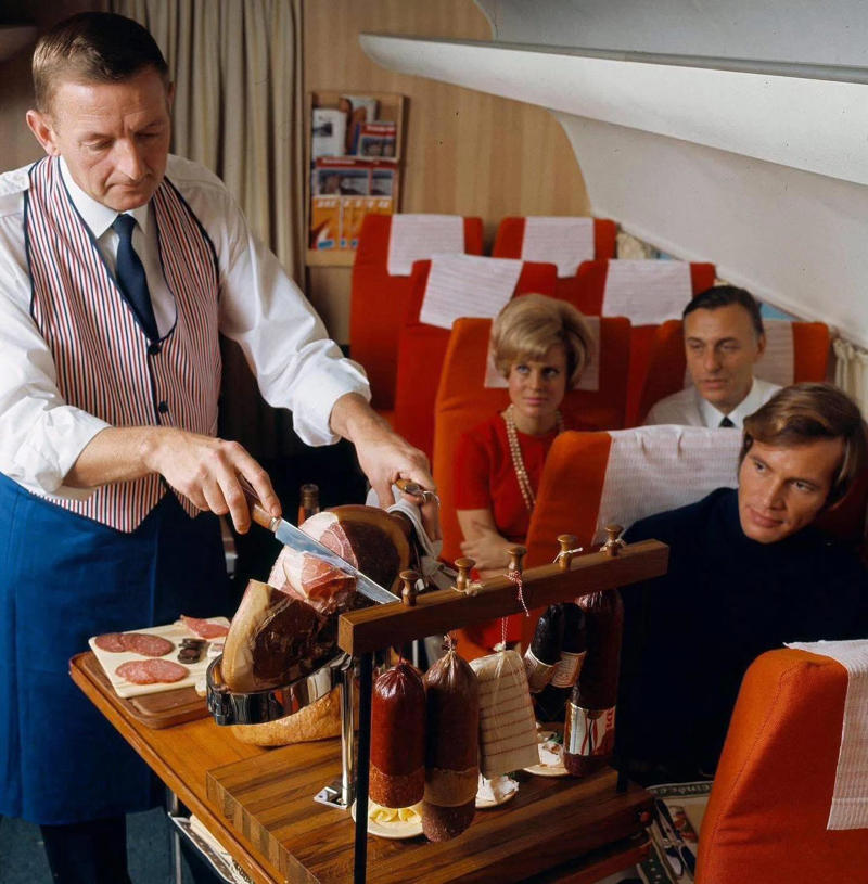 Seems like flying was basically a deli dream. Welcome to the golden age of flying!, The sky and cocktail lounge era., Not just a plane, it was a flying party lounge., This Japan Airlines cabin looked like a flying art gallery., Seems like flying was basically a deli dream., Groove was in the skies., Cocktail hour in the clouds was a must., Airline lounges? More like a Bond movie set., When the in-flight meal came with real plates., Sipping and playing cards. Pure bliss., Back when everyone had lounge access., No baggage fees, just smiles and drinks., Conversation pods for a cruising altitude., Studio 54 with some light turbulence., First class or a retro nightclub?, Beef Wellington at 30,000 feet., No turbulence, just a toast in the aisle., Fresh fruit? Yes, please.