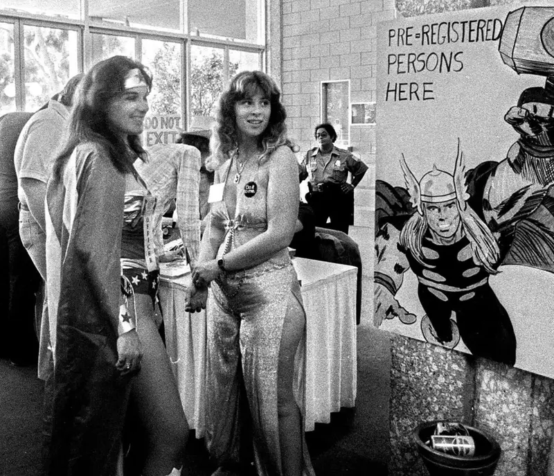 10. Comic-Con San Diego in 1980 Captures the Wild Beginnings of Pop Culture Fandom 1. Waiting In Line to See Star Wars, 1977, 2. January 19th 1977, The One and Only Day it Snowed in Miami, 3. Disco Sally, a 78-Year-Old Studio 54 Regular, Becomes a Symbol of the Era in 1978, 4. A Businessman Lights a Cigarette Inside a New York City Phone Booth in 1980, 5. Two Women Sit Casually on a Fire Escape in Harlem, NYC, in 1978, 6. Harrison Ford Appears as Colonel G. Lucas in Apocalypse Now, 1979, 7. In 1978, a Toddler Poses Next to the Family's New Color TV Like It's a Family Member, 8. Salesmen Sit on the Hoods of New Cars Waiting for Buyers at a California Dealership in 1979, 9. Kids Jump From a Fire Escape Onto Mattresses in NYC's Lower East Side, 1979, 10. Comic-Con San Diego in 1980 Captures the Wild Beginnings of Pop Culture Fandom, 11. The World's Largest Disco Draws Crowds to Buffalo in 1978, 12. Young Roller Skater in Red Moves Through Midtown Manhattan, 1979, 13. In 1978, Disco Dancing Lessons Spread to Suburbs Like Beaverton, Oregon, 14. An Apple II Computer and a Young Steve Jobs Revolutionize Tech in 1977, 15. A Woman Leans in to Kiss a Windsor Guard in a Whimsical Moment, 1980, 16. Two Guys Play Atari in Their Living Room in 1978, Defining Home Entertainment, 17. National Space Invaders Championship in 1980 Showcases a New Era of Gamers, 18. A Local News Crew in Texas Interviews Parents After Taking Kids to See Alien, 1979, 19. Young Woman in a "Consenting Adult" Shirt Enjoys the Rolling Stones in 1978, 20. In 1979, Reflections on the Dance Floor Captured the Disco Craze From Above, 21. A Canadian Gas Station Refuses to Fuel Soviet Ladas to Protest the Invasion of Afghanistan, 1980, 22. Subway Riders Carry Lawn Chairs for a Beach Day in NYC, Summer 1978, 23. High School Seniors Pose Before Heading on a Ski Trip in 1980, 24. Young Girl Embraces Teddy Boy Fashion and Rock 'n' Roll Dancing, 1979, 25. In 1980, Bronx Teens Turn the Streets Into a Stage With BMX Tricks, 26. Olivia Newton-John and John Travolta Redefine Teen Style on the Set of Grease, 1978, 27. KISS Fans in Buffalo, NY, Fully Embrace Glam Rock Culture, 1978, 28. New UK Prime Minister Margaret Thatcher Celebrates Her Election Victory, 1979, 29. The Sony Walkman Hits the Market With a Bold Ad Declaring "There's a Revolution in the Streets", 1980, 30. A Young Man Spins the Top Hits of 1978 on AM Radio Studio, 31. Four New Jersey Teens Check Under the Hood of a Car With a Backwards Design, 1979, 32. Elvis Presley's Final Performance in 1977 Leaves Fans With an Iconic Farewell, 33. Protesters Flood the Capitol in March 1980 to Oppose Military Draft Registration, 34. Staten Island Families Resort to Kerosene Lamps During the 1977 Blackout