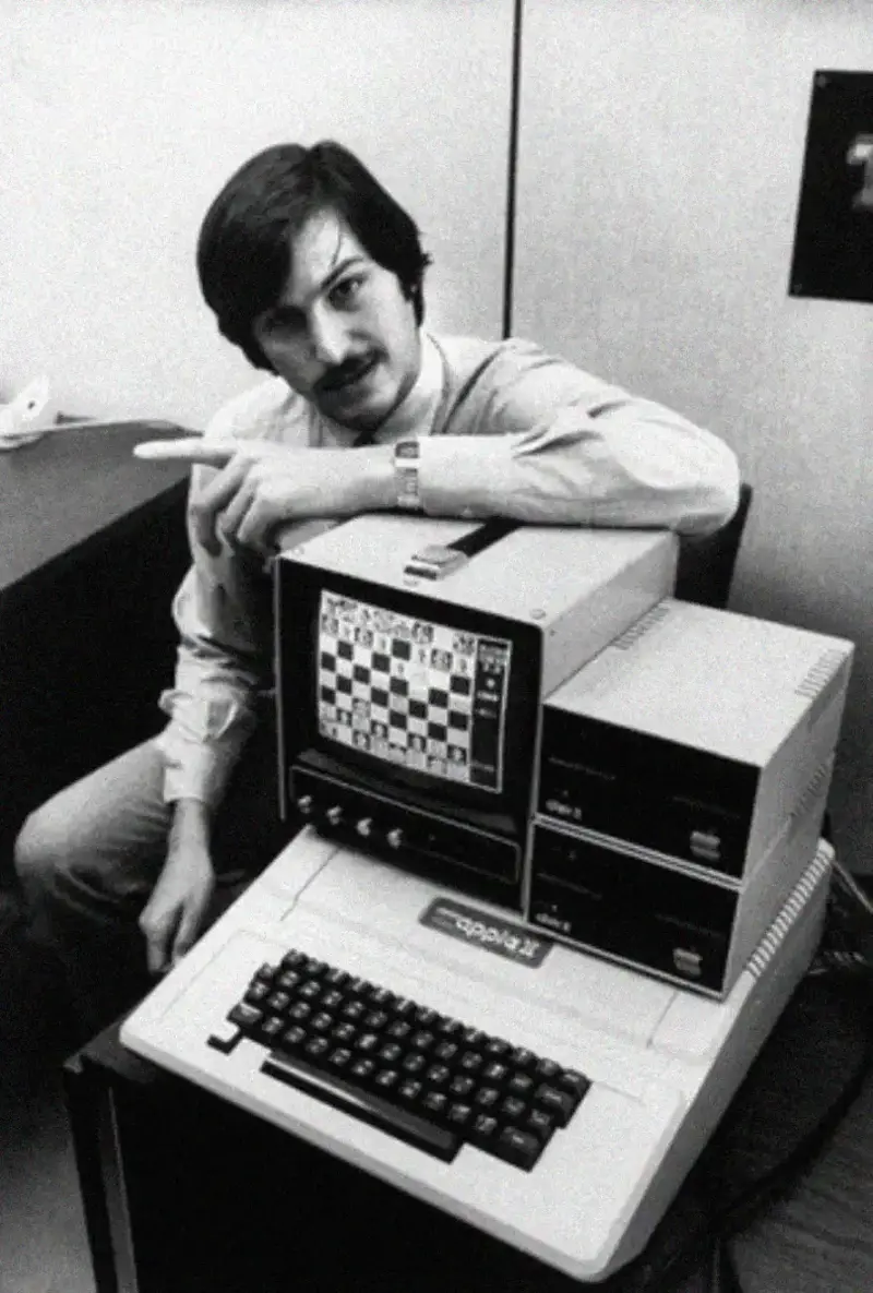 14. An Apple II Computer and a Young Steve Jobs Revolutionize Tech in 1977 1. Waiting In Line to See Star Wars, 1977, 2. January 19th 1977, The One and Only Day it Snowed in Miami, 3. Disco Sally, a 78-Year-Old Studio 54 Regular, Becomes a Symbol of the Era in 1978, 4. A Businessman Lights a Cigarette Inside a New York City Phone Booth in 1980, 5. Two Women Sit Casually on a Fire Escape in Harlem, NYC, in 1978, 6. Harrison Ford Appears as Colonel G. Lucas in Apocalypse Now, 1979, 7. In 1978, a Toddler Poses Next to the Family's New Color TV Like It's a Family Member, 8. Salesmen Sit on the Hoods of New Cars Waiting for Buyers at a California Dealership in 1979, 9. Kids Jump From a Fire Escape Onto Mattresses in NYC's Lower East Side, 1979, 10. Comic-Con San Diego in 1980 Captures the Wild Beginnings of Pop Culture Fandom, 11. The World's Largest Disco Draws Crowds to Buffalo in 1978, 12. Young Roller Skater in Red Moves Through Midtown Manhattan, 1979, 13. In 1978, Disco Dancing Lessons Spread to Suburbs Like Beaverton, Oregon, 14. An Apple II Computer and a Young Steve Jobs Revolutionize Tech in 1977, 15. A Woman Leans in to Kiss a Windsor Guard in a Whimsical Moment, 1980, 16. Two Guys Play Atari in Their Living Room in 1978, Defining Home Entertainment, 17. National Space Invaders Championship in 1980 Showcases a New Era of Gamers, 18. A Local News Crew in Texas Interviews Parents After Taking Kids to See Alien, 1979, 19. Young Woman in a "Consenting Adult" Shirt Enjoys the Rolling Stones in 1978, 20. In 1979, Reflections on the Dance Floor Captured the Disco Craze From Above, 21. A Canadian Gas Station Refuses to Fuel Soviet Ladas to Protest the Invasion of Afghanistan, 1980, 22. Subway Riders Carry Lawn Chairs for a Beach Day in NYC, Summer 1978, 23. High School Seniors Pose Before Heading on a Ski Trip in 1980, 24. Young Girl Embraces Teddy Boy Fashion and Rock 'n' Roll Dancing, 1979, 25. In 1980, Bronx Teens Turn the Streets Into a Stage With BMX Tricks, 26. Olivia Newton-John and John Travolta Redefine Teen Style on the Set of Grease, 1978, 27. KISS Fans in Buffalo, NY, Fully Embrace Glam Rock Culture, 1978, 28. New UK Prime Minister Margaret Thatcher Celebrates Her Election Victory, 1979, 29. The Sony Walkman Hits the Market With a Bold Ad Declaring "There's a Revolution in the Streets", 1980, 30. A Young Man Spins the Top Hits of 1978 on AM Radio Studio, 31. Four New Jersey Teens Check Under the Hood of a Car With a Backwards Design, 1979, 32. Elvis Presley's Final Performance in 1977 Leaves Fans With an Iconic Farewell, 33. Protesters Flood the Capitol in March 1980 to Oppose Military Draft Registration, 34. Staten Island Families Resort to Kerosene Lamps During the 1977 Blackout