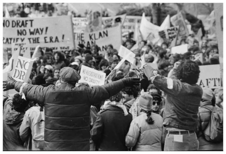 33. Protesters Flood the Capitol in March 1980 to Oppose Military Draft Registration 1. Waiting In Line to See Star Wars, 1977, 2. January 19th 1977, The One and Only Day it Snowed in Miami, 3. Disco Sally, a 78-Year-Old Studio 54 Regular, Becomes a Symbol of the Era in 1978, 4. A Businessman Lights a Cigarette Inside a New York City Phone Booth in 1980, 5. Two Women Sit Casually on a Fire Escape in Harlem, NYC, in 1978, 6. Harrison Ford Appears as Colonel G. Lucas in Apocalypse Now, 1979, 7. In 1978, a Toddler Poses Next to the Family's New Color TV Like It's a Family Member, 8. Salesmen Sit on the Hoods of New Cars Waiting for Buyers at a California Dealership in 1979, 9. Kids Jump From a Fire Escape Onto Mattresses in NYC's Lower East Side, 1979, 10. Comic-Con San Diego in 1980 Captures the Wild Beginnings of Pop Culture Fandom, 11. The World's Largest Disco Draws Crowds to Buffalo in 1978, 12. Young Roller Skater in Red Moves Through Midtown Manhattan, 1979, 13. In 1978, Disco Dancing Lessons Spread to Suburbs Like Beaverton, Oregon, 14. An Apple II Computer and a Young Steve Jobs Revolutionize Tech in 1977, 15. A Woman Leans in to Kiss a Windsor Guard in a Whimsical Moment, 1980, 16. Two Guys Play Atari in Their Living Room in 1978, Defining Home Entertainment, 17. National Space Invaders Championship in 1980 Showcases a New Era of Gamers, 18. A Local News Crew in Texas Interviews Parents After Taking Kids to See Alien, 1979, 19. Young Woman in a "Consenting Adult" Shirt Enjoys the Rolling Stones in 1978, 20. In 1979, Reflections on the Dance Floor Captured the Disco Craze From Above, 21. A Canadian Gas Station Refuses to Fuel Soviet Ladas to Protest the Invasion of Afghanistan, 1980, 22. Subway Riders Carry Lawn Chairs for a Beach Day in NYC, Summer 1978, 23. High School Seniors Pose Before Heading on a Ski Trip in 1980, 24. Young Girl Embraces Teddy Boy Fashion and Rock 'n' Roll Dancing, 1979, 25. In 1980, Bronx Teens Turn the Streets Into a Stage With BMX Tricks, 26. Olivia Newton-John and John Travolta Redefine Teen Style on the Set of Grease, 1978, 27. KISS Fans in Buffalo, NY, Fully Embrace Glam Rock Culture, 1978, 28. New UK Prime Minister Margaret Thatcher Celebrates Her Election Victory, 1979, 29. The Sony Walkman Hits the Market With a Bold Ad Declaring "There's a Revolution in the Streets", 1980, 30. A Young Man Spins the Top Hits of 1978 on AM Radio Studio, 31. Four New Jersey Teens Check Under the Hood of a Car With a Backwards Design, 1979, 32. Elvis Presley's Final Performance in 1977 Leaves Fans With an Iconic Farewell, 33. Protesters Flood the Capitol in March 1980 to Oppose Military Draft Registration, 34. Staten Island Families Resort to Kerosene Lamps During the 1977 Blackout