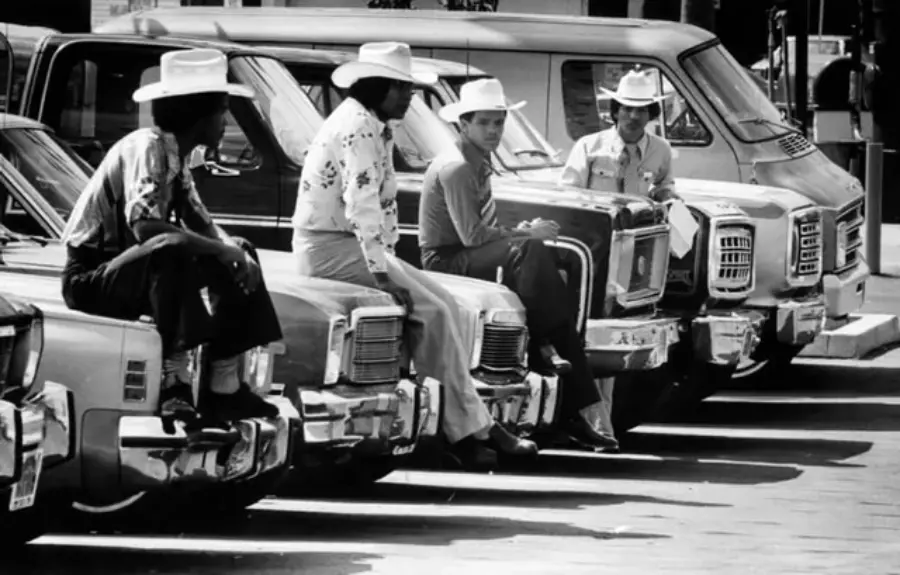 8. Salesmen Sit on the Hoods of New Cars Waiting for Buyers at a California Dealership in 1979 1. Waiting In Line to See Star Wars, 1977, 2. January 19th 1977, The One and Only Day it Snowed in Miami, 3. Disco Sally, a 78-Year-Old Studio 54 Regular, Becomes a Symbol of the Era in 1978, 4. A Businessman Lights a Cigarette Inside a New York City Phone Booth in 1980, 5. Two Women Sit Casually on a Fire Escape in Harlem, NYC, in 1978, 6. Harrison Ford Appears as Colonel G. Lucas in Apocalypse Now, 1979, 7. In 1978, a Toddler Poses Next to the Family's New Color TV Like It's a Family Member, 8. Salesmen Sit on the Hoods of New Cars Waiting for Buyers at a California Dealership in 1979, 9. Kids Jump From a Fire Escape Onto Mattresses in NYC's Lower East Side, 1979, 10. Comic-Con San Diego in 1980 Captures the Wild Beginnings of Pop Culture Fandom, 11. The World's Largest Disco Draws Crowds to Buffalo in 1978, 12. Young Roller Skater in Red Moves Through Midtown Manhattan, 1979, 13. In 1978, Disco Dancing Lessons Spread to Suburbs Like Beaverton, Oregon, 14. An Apple II Computer and a Young Steve Jobs Revolutionize Tech in 1977, 15. A Woman Leans in to Kiss a Windsor Guard in a Whimsical Moment, 1980, 16. Two Guys Play Atari in Their Living Room in 1978, Defining Home Entertainment, 17. National Space Invaders Championship in 1980 Showcases a New Era of Gamers, 18. A Local News Crew in Texas Interviews Parents After Taking Kids to See Alien, 1979, 19. Young Woman in a "Consenting Adult" Shirt Enjoys the Rolling Stones in 1978, 20. In 1979, Reflections on the Dance Floor Captured the Disco Craze From Above, 21. A Canadian Gas Station Refuses to Fuel Soviet Ladas to Protest the Invasion of Afghanistan, 1980, 22. Subway Riders Carry Lawn Chairs for a Beach Day in NYC, Summer 1978, 23. High School Seniors Pose Before Heading on a Ski Trip in 1980, 24. Young Girl Embraces Teddy Boy Fashion and Rock 'n' Roll Dancing, 1979, 25. In 1980, Bronx Teens Turn the Streets Into a Stage With BMX Tricks, 26. Olivia Newton-John and John Travolta Redefine Teen Style on the Set of Grease, 1978, 27. KISS Fans in Buffalo, NY, Fully Embrace Glam Rock Culture, 1978, 28. New UK Prime Minister Margaret Thatcher Celebrates Her Election Victory, 1979, 29. The Sony Walkman Hits the Market With a Bold Ad Declaring "There's a Revolution in the Streets", 1980, 30. A Young Man Spins the Top Hits of 1978 on AM Radio Studio, 31. Four New Jersey Teens Check Under the Hood of a Car With a Backwards Design, 1979, 32. Elvis Presley's Final Performance in 1977 Leaves Fans With an Iconic Farewell, 33. Protesters Flood the Capitol in March 1980 to Oppose Military Draft Registration, 34. Staten Island Families Resort to Kerosene Lamps During the 1977 Blackout