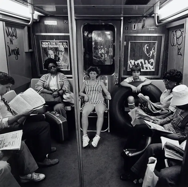 22. Subway Riders Carry Lawn Chairs for a Beach Day in NYC, Summer 1978 1. Waiting In Line to See Star Wars, 1977, 2. January 19th 1977, The One and Only Day it Snowed in Miami, 3. Disco Sally, a 78-Year-Old Studio 54 Regular, Becomes a Symbol of the Era in 1978, 4. A Businessman Lights a Cigarette Inside a New York City Phone Booth in 1980, 5. Two Women Sit Casually on a Fire Escape in Harlem, NYC, in 1978, 6. Harrison Ford Appears as Colonel G. Lucas in Apocalypse Now, 1979, 7. In 1978, a Toddler Poses Next to the Family's New Color TV Like It's a Family Member, 8. Salesmen Sit on the Hoods of New Cars Waiting for Buyers at a California Dealership in 1979, 9. Kids Jump From a Fire Escape Onto Mattresses in NYC's Lower East Side, 1979, 10. Comic-Con San Diego in 1980 Captures the Wild Beginnings of Pop Culture Fandom, 11. The World's Largest Disco Draws Crowds to Buffalo in 1978, 12. Young Roller Skater in Red Moves Through Midtown Manhattan, 1979, 13. In 1978, Disco Dancing Lessons Spread to Suburbs Like Beaverton, Oregon, 14. An Apple II Computer and a Young Steve Jobs Revolutionize Tech in 1977, 15. A Woman Leans in to Kiss a Windsor Guard in a Whimsical Moment, 1980, 16. Two Guys Play Atari in Their Living Room in 1978, Defining Home Entertainment, 17. National Space Invaders Championship in 1980 Showcases a New Era of Gamers, 18. A Local News Crew in Texas Interviews Parents After Taking Kids to See Alien, 1979, 19. Young Woman in a "Consenting Adult" Shirt Enjoys the Rolling Stones in 1978, 20. In 1979, Reflections on the Dance Floor Captured the Disco Craze From Above, 21. A Canadian Gas Station Refuses to Fuel Soviet Ladas to Protest the Invasion of Afghanistan, 1980, 22. Subway Riders Carry Lawn Chairs for a Beach Day in NYC, Summer 1978, 23. High School Seniors Pose Before Heading on a Ski Trip in 1980, 24. Young Girl Embraces Teddy Boy Fashion and Rock 'n' Roll Dancing, 1979, 25. In 1980, Bronx Teens Turn the Streets Into a Stage With BMX Tricks, 26. Olivia Newton-John and John Travolta Redefine Teen Style on the Set of Grease, 1978, 27. KISS Fans in Buffalo, NY, Fully Embrace Glam Rock Culture, 1978, 28. New UK Prime Minister Margaret Thatcher Celebrates Her Election Victory, 1979, 29. The Sony Walkman Hits the Market With a Bold Ad Declaring "There's a Revolution in the Streets", 1980, 30. A Young Man Spins the Top Hits of 1978 on AM Radio Studio, 31. Four New Jersey Teens Check Under the Hood of a Car With a Backwards Design, 1979, 32. Elvis Presley's Final Performance in 1977 Leaves Fans With an Iconic Farewell, 33. Protesters Flood the Capitol in March 1980 to Oppose Military Draft Registration, 34. Staten Island Families Resort to Kerosene Lamps During the 1977 Blackout