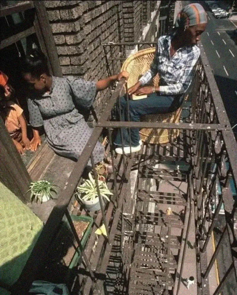 5. Two Women Sit Casually on a Fire Escape in Harlem, NYC, in 1978 1. Waiting In Line to See Star Wars, 1977, 2. January 19th 1977, The One and Only Day it Snowed in Miami, 3. Disco Sally, a 78-Year-Old Studio 54 Regular, Becomes a Symbol of the Era in 1978, 4. A Businessman Lights a Cigarette Inside a New York City Phone Booth in 1980, 5. Two Women Sit Casually on a Fire Escape in Harlem, NYC, in 1978, 6. Harrison Ford Appears as Colonel G. Lucas in Apocalypse Now, 1979, 7. In 1978, a Toddler Poses Next to the Family's New Color TV Like It's a Family Member, 8. Salesmen Sit on the Hoods of New Cars Waiting for Buyers at a California Dealership in 1979, 9. Kids Jump From a Fire Escape Onto Mattresses in NYC's Lower East Side, 1979, 10. Comic-Con San Diego in 1980 Captures the Wild Beginnings of Pop Culture Fandom, 11. The World's Largest Disco Draws Crowds to Buffalo in 1978, 12. Young Roller Skater in Red Moves Through Midtown Manhattan, 1979, 13. In 1978, Disco Dancing Lessons Spread to Suburbs Like Beaverton, Oregon, 14. An Apple II Computer and a Young Steve Jobs Revolutionize Tech in 1977, 15. A Woman Leans in to Kiss a Windsor Guard in a Whimsical Moment, 1980, 16. Two Guys Play Atari in Their Living Room in 1978, Defining Home Entertainment, 17. National Space Invaders Championship in 1980 Showcases a New Era of Gamers, 18. A Local News Crew in Texas Interviews Parents After Taking Kids to See Alien, 1979, 19. Young Woman in a "Consenting Adult" Shirt Enjoys the Rolling Stones in 1978, 20. In 1979, Reflections on the Dance Floor Captured the Disco Craze From Above, 21. A Canadian Gas Station Refuses to Fuel Soviet Ladas to Protest the Invasion of Afghanistan, 1980, 22. Subway Riders Carry Lawn Chairs for a Beach Day in NYC, Summer 1978, 23. High School Seniors Pose Before Heading on a Ski Trip in 1980, 24. Young Girl Embraces Teddy Boy Fashion and Rock 'n' Roll Dancing, 1979, 25. In 1980, Bronx Teens Turn the Streets Into a Stage With BMX Tricks, 26. Olivia Newton-John and John Travolta Redefine Teen Style on the Set of Grease, 1978, 27. KISS Fans in Buffalo, NY, Fully Embrace Glam Rock Culture, 1978, 28. New UK Prime Minister Margaret Thatcher Celebrates Her Election Victory, 1979, 29. The Sony Walkman Hits the Market With a Bold Ad Declaring "There's a Revolution in the Streets", 1980, 30. A Young Man Spins the Top Hits of 1978 on AM Radio Studio, 31. Four New Jersey Teens Check Under the Hood of a Car With a Backwards Design, 1979, 32. Elvis Presley's Final Performance in 1977 Leaves Fans With an Iconic Farewell, 33. Protesters Flood the Capitol in March 1980 to Oppose Military Draft Registration, 34. Staten Island Families Resort to Kerosene Lamps During the 1977 Blackout