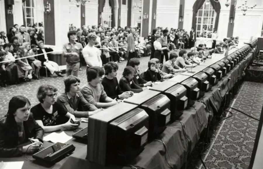17. National Space Invaders Championship in 1980 Showcases a New Era of Gamers 1. Waiting In Line to See Star Wars, 1977, 2. January 19th 1977, The One and Only Day it Snowed in Miami, 3. Disco Sally, a 78-Year-Old Studio 54 Regular, Becomes a Symbol of the Era in 1978, 4. A Businessman Lights a Cigarette Inside a New York City Phone Booth in 1980, 5. Two Women Sit Casually on a Fire Escape in Harlem, NYC, in 1978, 6. Harrison Ford Appears as Colonel G. Lucas in Apocalypse Now, 1979, 7. In 1978, a Toddler Poses Next to the Family's New Color TV Like It's a Family Member, 8. Salesmen Sit on the Hoods of New Cars Waiting for Buyers at a California Dealership in 1979, 9. Kids Jump From a Fire Escape Onto Mattresses in NYC's Lower East Side, 1979, 10. Comic-Con San Diego in 1980 Captures the Wild Beginnings of Pop Culture Fandom, 11. The World's Largest Disco Draws Crowds to Buffalo in 1978, 12. Young Roller Skater in Red Moves Through Midtown Manhattan, 1979, 13. In 1978, Disco Dancing Lessons Spread to Suburbs Like Beaverton, Oregon, 14. An Apple II Computer and a Young Steve Jobs Revolutionize Tech in 1977, 15. A Woman Leans in to Kiss a Windsor Guard in a Whimsical Moment, 1980, 16. Two Guys Play Atari in Their Living Room in 1978, Defining Home Entertainment, 17. National Space Invaders Championship in 1980 Showcases a New Era of Gamers, 18. A Local News Crew in Texas Interviews Parents After Taking Kids to See Alien, 1979, 19. Young Woman in a "Consenting Adult" Shirt Enjoys the Rolling Stones in 1978, 20. In 1979, Reflections on the Dance Floor Captured the Disco Craze From Above, 21. A Canadian Gas Station Refuses to Fuel Soviet Ladas to Protest the Invasion of Afghanistan, 1980, 22. Subway Riders Carry Lawn Chairs for a Beach Day in NYC, Summer 1978, 23. High School Seniors Pose Before Heading on a Ski Trip in 1980, 24. Young Girl Embraces Teddy Boy Fashion and Rock 'n' Roll Dancing, 1979, 25. In 1980, Bronx Teens Turn the Streets Into a Stage With BMX Tricks, 26. Olivia Newton-John and John Travolta Redefine Teen Style on the Set of Grease, 1978, 27. KISS Fans in Buffalo, NY, Fully Embrace Glam Rock Culture, 1978, 28. New UK Prime Minister Margaret Thatcher Celebrates Her Election Victory, 1979, 29. The Sony Walkman Hits the Market With a Bold Ad Declaring "There's a Revolution in the Streets", 1980, 30. A Young Man Spins the Top Hits of 1978 on AM Radio Studio, 31. Four New Jersey Teens Check Under the Hood of a Car With a Backwards Design, 1979, 32. Elvis Presley's Final Performance in 1977 Leaves Fans With an Iconic Farewell, 33. Protesters Flood the Capitol in March 1980 to Oppose Military Draft Registration, 34. Staten Island Families Resort to Kerosene Lamps During the 1977 Blackout