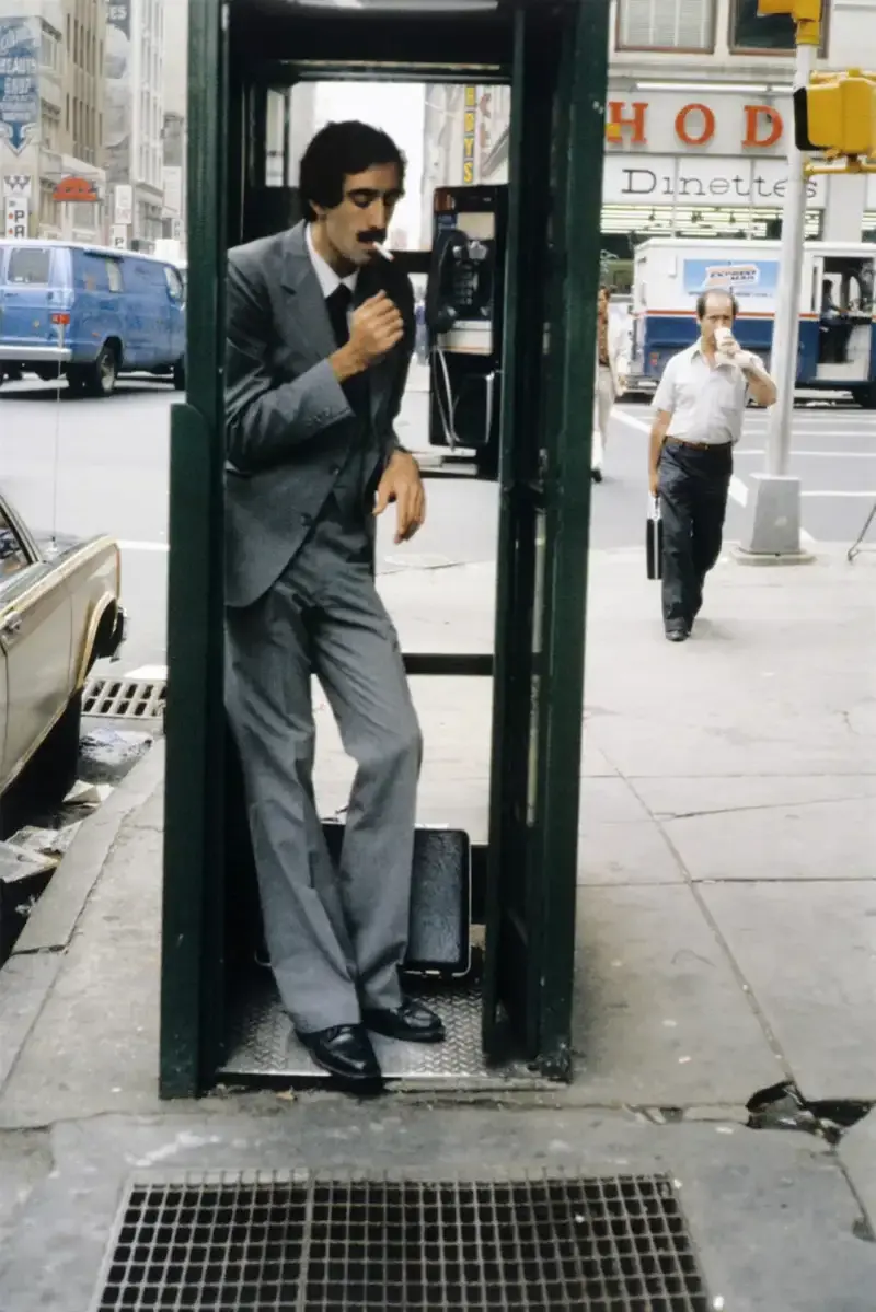 4. A Businessman Lights a Cigarette Inside a New York City Phone Booth in 1980 1. Waiting In Line to See Star Wars, 1977, 2. January 19th 1977, The One and Only Day it Snowed in Miami, 3. Disco Sally, a 78-Year-Old Studio 54 Regular, Becomes a Symbol of the Era in 1978, 4. A Businessman Lights a Cigarette Inside a New York City Phone Booth in 1980, 5. Two Women Sit Casually on a Fire Escape in Harlem, NYC, in 1978, 6. Harrison Ford Appears as Colonel G. Lucas in Apocalypse Now, 1979, 7. In 1978, a Toddler Poses Next to the Family's New Color TV Like It's a Family Member, 8. Salesmen Sit on the Hoods of New Cars Waiting for Buyers at a California Dealership in 1979, 9. Kids Jump From a Fire Escape Onto Mattresses in NYC's Lower East Side, 1979, 10. Comic-Con San Diego in 1980 Captures the Wild Beginnings of Pop Culture Fandom, 11. The World's Largest Disco Draws Crowds to Buffalo in 1978, 12. Young Roller Skater in Red Moves Through Midtown Manhattan, 1979, 13. In 1978, Disco Dancing Lessons Spread to Suburbs Like Beaverton, Oregon, 14. An Apple II Computer and a Young Steve Jobs Revolutionize Tech in 1977, 15. A Woman Leans in to Kiss a Windsor Guard in a Whimsical Moment, 1980, 16. Two Guys Play Atari in Their Living Room in 1978, Defining Home Entertainment, 17. National Space Invaders Championship in 1980 Showcases a New Era of Gamers, 18. A Local News Crew in Texas Interviews Parents After Taking Kids to See Alien, 1979, 19. Young Woman in a "Consenting Adult" Shirt Enjoys the Rolling Stones in 1978, 20. In 1979, Reflections on the Dance Floor Captured the Disco Craze From Above, 21. A Canadian Gas Station Refuses to Fuel Soviet Ladas to Protest the Invasion of Afghanistan, 1980, 22. Subway Riders Carry Lawn Chairs for a Beach Day in NYC, Summer 1978, 23. High School Seniors Pose Before Heading on a Ski Trip in 1980, 24. Young Girl Embraces Teddy Boy Fashion and Rock 'n' Roll Dancing, 1979, 25. In 1980, Bronx Teens Turn the Streets Into a Stage With BMX Tricks, 26. Olivia Newton-John and John Travolta Redefine Teen Style on the Set of Grease, 1978, 27. KISS Fans in Buffalo, NY, Fully Embrace Glam Rock Culture, 1978, 28. New UK Prime Minister Margaret Thatcher Celebrates Her Election Victory, 1979, 29. The Sony Walkman Hits the Market With a Bold Ad Declaring "There's a Revolution in the Streets", 1980, 30. A Young Man Spins the Top Hits of 1978 on AM Radio Studio, 31. Four New Jersey Teens Check Under the Hood of a Car With a Backwards Design, 1979, 32. Elvis Presley's Final Performance in 1977 Leaves Fans With an Iconic Farewell, 33. Protesters Flood the Capitol in March 1980 to Oppose Military Draft Registration, 34. Staten Island Families Resort to Kerosene Lamps During the 1977 Blackout