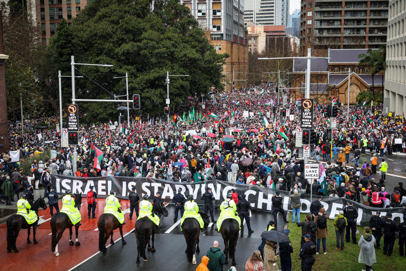 'Too many people' on bridge, organisers say, Miserable day but demonstrators march on, Protesters reach Sydney Harbour Bridge, Counter-protesters detained in Melbourne, Sydney's train stations packed with protesters, Thousands more expected to join march, Famous faces join protest, Police close Sydney Harbour Bridge, Drivers warned to avoid the city, Weather won't deter protesters in Sydney, Thousands to descend on Melbourne CBD