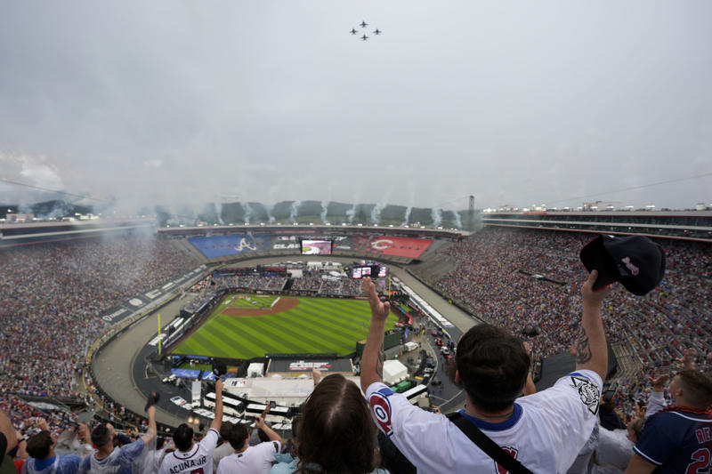 Pregame pageantry, Great spectacle, not a great view, Hall of Famers in the rain, Fewer fans returned after postponement, Bristol Motor Speedway swallows the baseball field, The Colossus looms, The Home Run Car goes racing, Checkered flag waves for Eli White