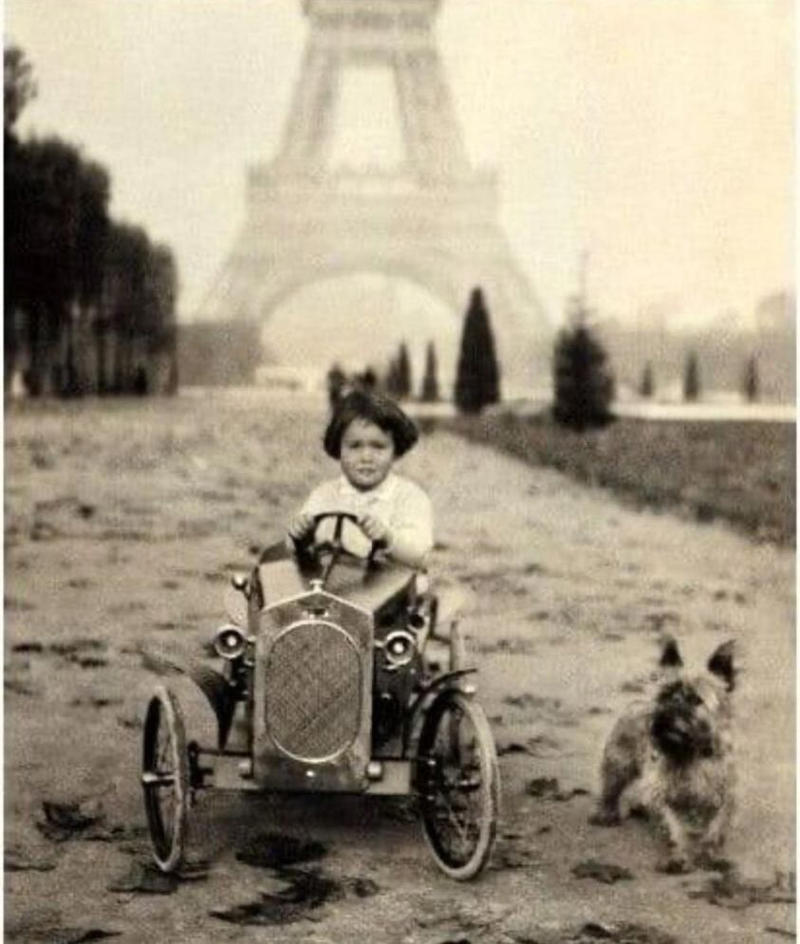 16. A Young Gloria Vanderbilt and Her Pet Dog Playing in Front of the Eiffel Tower, 1921 1. A Woman Strolls Through Paris While Reading the Paper, 2. Two Kids Play With a Toy Car on a Cobblestone Street With the Moulin Rouge in the Distance, 3. ‘A Pair of Lovers in Paris, France’, 4. Visitors Stroll Beneath the Eiffel Tower During the 1925 Exposition Internationale des Arts Décoratifs, 5. Colorized Image of Parisians Browsing Flowers Near the Tour de l’Horloge on the Île de la Cité, One of the City’s Oldest Clocks, 6. ‘Soldiers at the Metro Station Auteuil on the Boulevard Excelmans in Paris, France, on May 1, 1920’, 7. Colorized Image of a Hot Air Balloon Pre-Take Off, May 1923, 8. Two Women Enjoy a Coffee on a Terrace, 1925, 9. ‘A Street Scene in Paris During the 1924 Olympics’, 10. A Woman Enjoys a Meal Aboard a Zeppelin Heading to Berlin, 1928, 11. A Couple Dances Along the Seine as People Look on, 12. Singer and Dancer Josephine Baker Pictured at a Cabaret, 1927, 13. Three Children Pause for a Snack With the Sacré-Coeur in the Distance, 14. ‘Ernest Hemingway in Paris, 1920s’, 15. ‘Citroen Automobile Designed by Sonia Delaunay in Paris, 1925’, 16. A Young Gloria Vanderbilt and Her Pet Dog Playing in Front of the Eiffel Tower, 1921, 17. ‘Backstage at the Moulin Rouge, Paris, 1924’, 18. ‘Early Color Photography in Paris, France, 1920’, 19. Josephine Baker Taking Her Pet Cheetah for a Walk in Paris, 1923