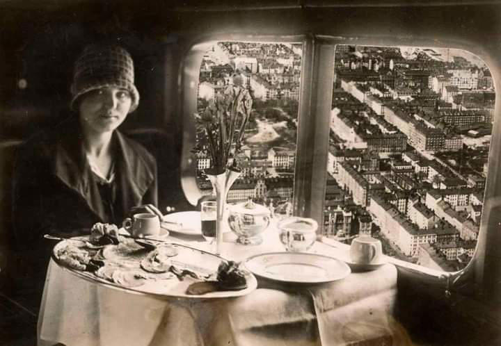 10. A Woman Enjoys a Meal Aboard a Zeppelin Heading to Berlin, 1928 1. A Woman Strolls Through Paris While Reading the Paper, 2. Two Kids Play With a Toy Car on a Cobblestone Street With the Moulin Rouge in the Distance, 3. ‘A Pair of Lovers in Paris, France’, 4. Visitors Stroll Beneath the Eiffel Tower During the 1925 Exposition Internationale des Arts Décoratifs, 5. Colorized Image of Parisians Browsing Flowers Near the Tour de l’Horloge on the Île de la Cité, One of the City’s Oldest Clocks, 6. ‘Soldiers at the Metro Station Auteuil on the Boulevard Excelmans in Paris, France, on May 1, 1920’, 7. Colorized Image of a Hot Air Balloon Pre-Take Off, May 1923, 8. Two Women Enjoy a Coffee on a Terrace, 1925, 9. ‘A Street Scene in Paris During the 1924 Olympics’, 10. A Woman Enjoys a Meal Aboard a Zeppelin Heading to Berlin, 1928, 11. A Couple Dances Along the Seine as People Look on, 12. Singer and Dancer Josephine Baker Pictured at a Cabaret, 1927, 13. Three Children Pause for a Snack With the Sacré-Coeur in the Distance, 14. ‘Ernest Hemingway in Paris, 1920s’, 15. ‘Citroen Automobile Designed by Sonia Delaunay in Paris, 1925’, 16. A Young Gloria Vanderbilt and Her Pet Dog Playing in Front of the Eiffel Tower, 1921, 17. ‘Backstage at the Moulin Rouge, Paris, 1924’, 18. ‘Early Color Photography in Paris, France, 1920’, 19. Josephine Baker Taking Her Pet Cheetah for a Walk in Paris, 1923