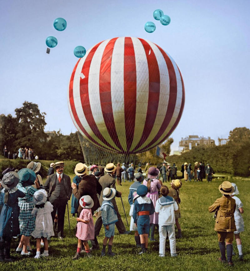 7. Colorized Image of a Hot Air Balloon Pre-Take Off, May 1923 1. A Woman Strolls Through Paris While Reading the Paper, 2. Two Kids Play With a Toy Car on a Cobblestone Street With the Moulin Rouge in the Distance, 3. ‘A Pair of Lovers in Paris, France’, 4. Visitors Stroll Beneath the Eiffel Tower During the 1925 Exposition Internationale des Arts Décoratifs, 5. Colorized Image of Parisians Browsing Flowers Near the Tour de l’Horloge on the Île de la Cité, One of the City’s Oldest Clocks, 6. ‘Soldiers at the Metro Station Auteuil on the Boulevard Excelmans in Paris, France, on May 1, 1920’, 7. Colorized Image of a Hot Air Balloon Pre-Take Off, May 1923, 8. Two Women Enjoy a Coffee on a Terrace, 1925, 9. ‘A Street Scene in Paris During the 1924 Olympics’, 10. A Woman Enjoys a Meal Aboard a Zeppelin Heading to Berlin, 1928, 11. A Couple Dances Along the Seine as People Look on, 12. Singer and Dancer Josephine Baker Pictured at a Cabaret, 1927, 13. Three Children Pause for a Snack With the Sacré-Coeur in the Distance, 14. ‘Ernest Hemingway in Paris, 1920s’, 15. ‘Citroen Automobile Designed by Sonia Delaunay in Paris, 1925’, 16. A Young Gloria Vanderbilt and Her Pet Dog Playing in Front of the Eiffel Tower, 1921, 17. ‘Backstage at the Moulin Rouge, Paris, 1924’, 18. ‘Early Color Photography in Paris, France, 1920’, 19. Josephine Baker Taking Her Pet Cheetah for a Walk in Paris, 1923