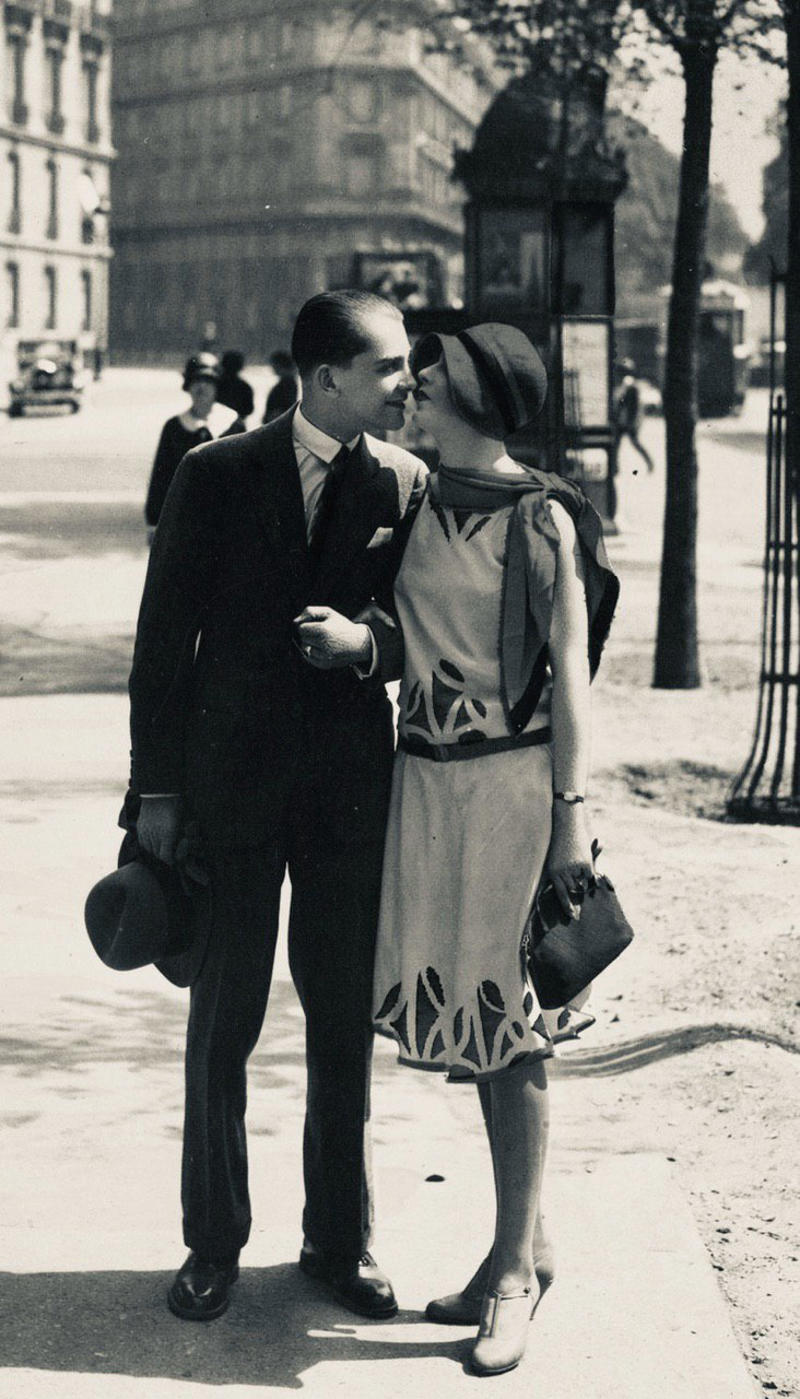 3. ‘A Pair of Lovers in Paris, France’ 1. A Woman Strolls Through Paris While Reading the Paper, 2. Two Kids Play With a Toy Car on a Cobblestone Street With the Moulin Rouge in the Distance, 3. ‘A Pair of Lovers in Paris, France’, 4. Visitors Stroll Beneath the Eiffel Tower During the 1925 Exposition Internationale des Arts Décoratifs, 5. Colorized Image of Parisians Browsing Flowers Near the Tour de l’Horloge on the Île de la Cité, One of the City’s Oldest Clocks, 6. ‘Soldiers at the Metro Station Auteuil on the Boulevard Excelmans in Paris, France, on May 1, 1920’, 7. Colorized Image of a Hot Air Balloon Pre-Take Off, May 1923, 8. Two Women Enjoy a Coffee on a Terrace, 1925, 9. ‘A Street Scene in Paris During the 1924 Olympics’, 10. A Woman Enjoys a Meal Aboard a Zeppelin Heading to Berlin, 1928, 11. A Couple Dances Along the Seine as People Look on, 12. Singer and Dancer Josephine Baker Pictured at a Cabaret, 1927, 13. Three Children Pause for a Snack With the Sacré-Coeur in the Distance, 14. ‘Ernest Hemingway in Paris, 1920s’, 15. ‘Citroen Automobile Designed by Sonia Delaunay in Paris, 1925’, 16. A Young Gloria Vanderbilt and Her Pet Dog Playing in Front of the Eiffel Tower, 1921, 17. ‘Backstage at the Moulin Rouge, Paris, 1924’, 18. ‘Early Color Photography in Paris, France, 1920’, 19. Josephine Baker Taking Her Pet Cheetah for a Walk in Paris, 1923