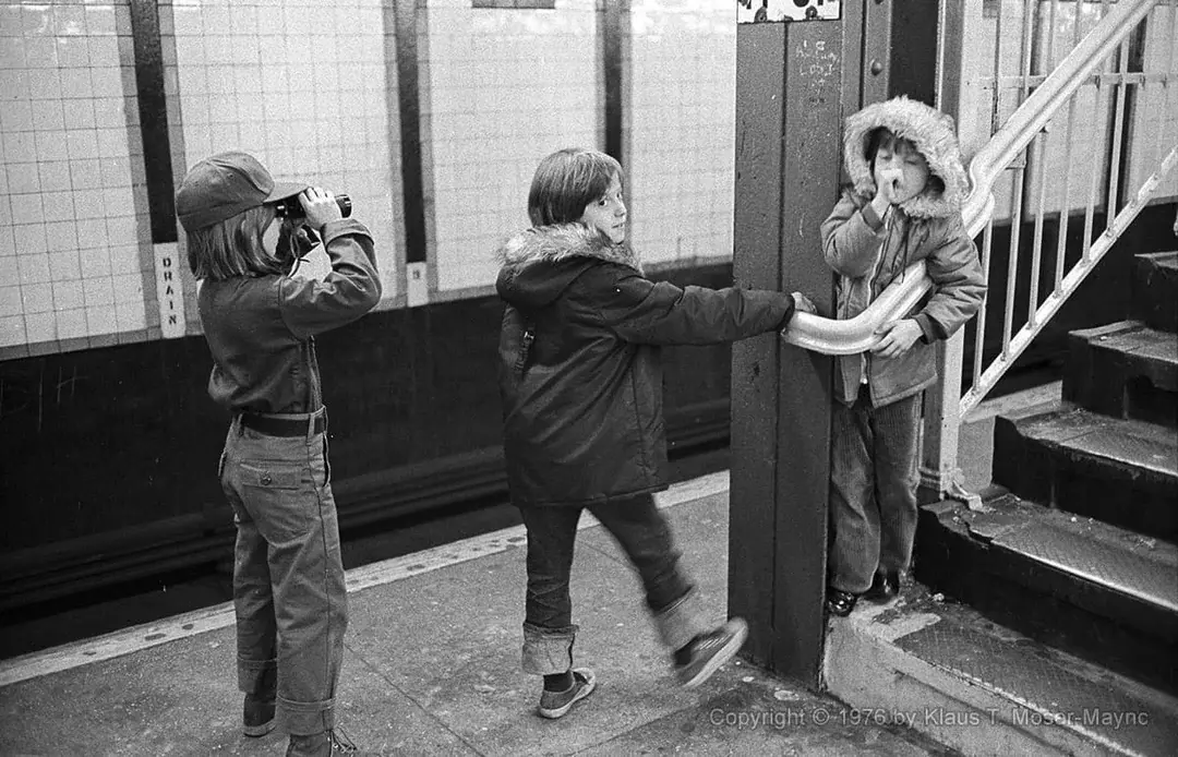 23. A Group of Kids Waits Patiently for the Subway in a Gritty 1976 New York City 1. Queen Was on Fire in 1976, Even if the Hairstyles Were Questionable, 2. The Hudson River Lit Up with Boats and Patriotism on the 4th of July, 1976, 3. Barefoot and Beaming, Locals Paraded with Pride Through Pickering Beach in 1976, 4. A Helpful Hand at Kmart's Camera Counter as Film Photography Ruled 1976, 5. A Snapshot of LA Youth in the Summer of '76, 6. Festive Fries and Holiday Cheer at McDonald's in the Heart of the Seventies, 7. Marching to the Beat of Freedom During the 1976 Bicentennial Celebration, 8. A Fall Night on Broadway and 44th in 1976 Manhattan, 9. Candlelit Conversations and Cozy Vibes at a 1976 House Party, 10. This Toddler Had Style to Spare in 1976, 11. Lazy Beach Days and Summer Love in South Shields, 1976, 12. Packed Nights and Rock 'n' Roll Vibes Inside Max's Kansas City, NYC, 1976, 13. Americans Gather Around the Bicentennial "Freedom Train" Carrying Priceless Pieces of History, 14. Teenage Love Caught on Camera in a Quiet New York Room, 1976, 15. Chaos and Cheers at the Battle Royal in L.A.'s Olympic Auditorium, 16. Jodie Foster Stuns at Just 14 in the Gritty Classic Taxi Driver, 1976, 17. The Power of Christ Compels You at Detroit’s Infamous Exorcist Lounge, 1976, 18. Arcade Dreams and Mall Magic Collide at Old Chicago in 1976, 19. School Vaccinations in 1976 Highland Park, 20. Dancing in the Streets of Brooklyn During A Joyful Block Party Moment in 1976, 21. Serving Up Street Flavor Outside the Met on a Summer Day in 1976, 22. A Group of Kids Waits Patiently for the Subway in a Gritty 1976 New York City, 23. Neighborhood Kids Gear Up for Halloween With Their Spookiest Masks in 1976, 24. President Jimmy Carter Casually Hops a Fence at LaGuardia Airport With an Aide, 1976, 25. Dining Above the Clouds at Windows on the World, 1976, 26. David Bowie in 1976, Redefining Cool with Every Glance, 27. AC/DC Rocking Their Way to Global Fame in 1976, 28. A Young Woman Hitchhiking Through Florida's Sun-Soaked Highways in 1976, 29. A Group of Young Concertgoers Soaking Up the Vibes in Ohio, 30. A Surprising Snapshot of Hollywood Charm, 31. When Superheroes Took the Plunge at SeaWorld's Wild 1976 Show, 32. Charlie's Angels Redefined Cool and Confidence in 1976, 33. Kiss Turns Heads While Strutting Through NYC in Full Costume, 1976