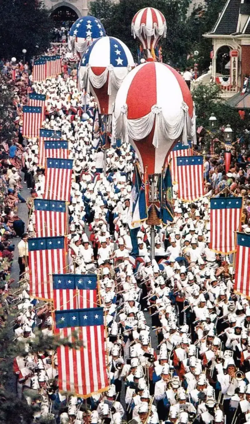 7. Marching to the Beat of Freedom During the 1976 Bicentennial Celebration 1. Queen Was on Fire in 1976, Even if the Hairstyles Were Questionable, 2. The Hudson River Lit Up with Boats and Patriotism on the 4th of July, 1976, 3. Barefoot and Beaming, Locals Paraded with Pride Through Pickering Beach in 1976, 4. A Helpful Hand at Kmart's Camera Counter as Film Photography Ruled 1976, 5. A Snapshot of LA Youth in the Summer of '76, 6. Festive Fries and Holiday Cheer at McDonald's in the Heart of the Seventies, 7. Marching to the Beat of Freedom During the 1976 Bicentennial Celebration, 8. A Fall Night on Broadway and 44th in 1976 Manhattan, 9. Candlelit Conversations and Cozy Vibes at a 1976 House Party, 10. This Toddler Had Style to Spare in 1976, 11. Lazy Beach Days and Summer Love in South Shields, 1976, 12. Packed Nights and Rock 'n' Roll Vibes Inside Max's Kansas City, NYC, 1976, 13. Americans Gather Around the Bicentennial "Freedom Train" Carrying Priceless Pieces of History, 14. Teenage Love Caught on Camera in a Quiet New York Room, 1976, 15. Chaos and Cheers at the Battle Royal in L.A.'s Olympic Auditorium, 16. Jodie Foster Stuns at Just 14 in the Gritty Classic Taxi Driver, 1976, 17. The Power of Christ Compels You at Detroit’s Infamous Exorcist Lounge, 1976, 18. Arcade Dreams and Mall Magic Collide at Old Chicago in 1976, 19. School Vaccinations in 1976 Highland Park, 20. Dancing in the Streets of Brooklyn During A Joyful Block Party Moment in 1976, 21. Serving Up Street Flavor Outside the Met on a Summer Day in 1976, 22. A Group of Kids Waits Patiently for the Subway in a Gritty 1976 New York City, 23. Neighborhood Kids Gear Up for Halloween With Their Spookiest Masks in 1976, 24. President Jimmy Carter Casually Hops a Fence at LaGuardia Airport With an Aide, 1976, 25. Dining Above the Clouds at Windows on the World, 1976, 26. David Bowie in 1976, Redefining Cool with Every Glance, 27. AC/DC Rocking Their Way to Global Fame in 1976, 28. A Young Woman Hitchhiking Through Florida's Sun-Soaked Highways in 1976, 29. A Group of Young Concertgoers Soaking Up the Vibes in Ohio, 30. A Surprising Snapshot of Hollywood Charm, 31. When Superheroes Took the Plunge at SeaWorld's Wild 1976 Show, 32. Charlie's Angels Redefined Cool and Confidence in 1976, 33. Kiss Turns Heads While Strutting Through NYC in Full Costume, 1976