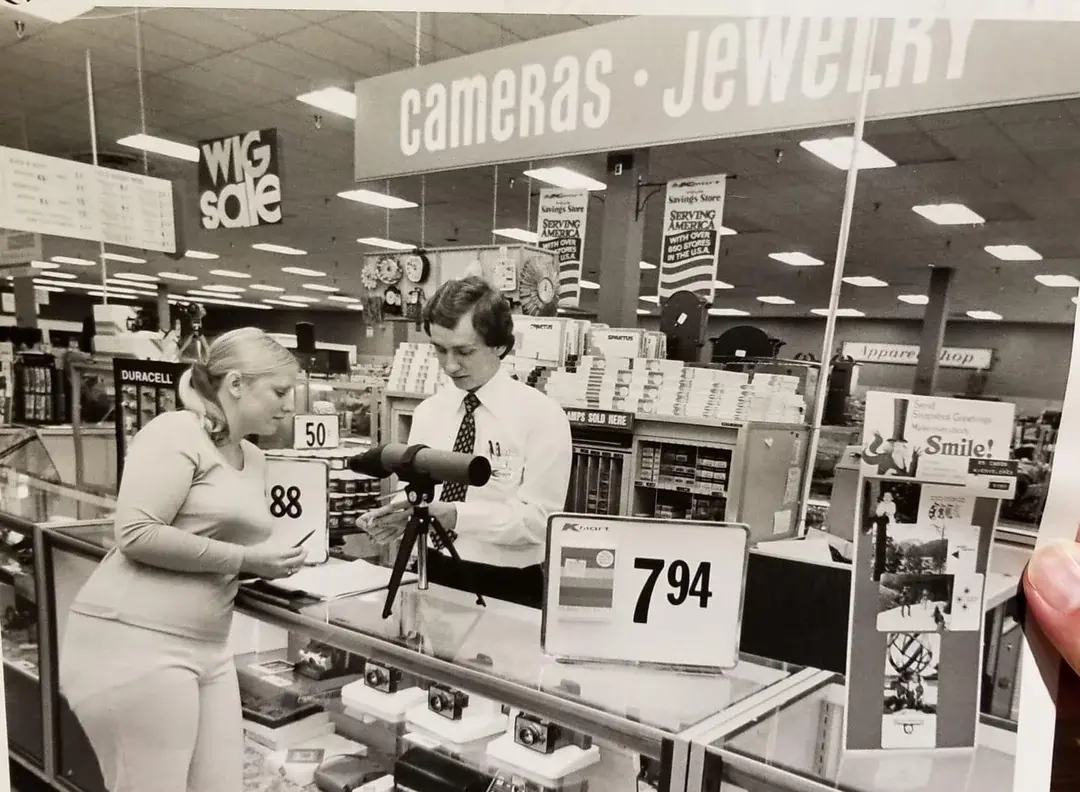 4. A Helpful Hand at Kmart's Camera Counter as Film Photography Ruled 1976 1. Queen Was on Fire in 1976, Even if the Hairstyles Were Questionable, 2. The Hudson River Lit Up with Boats and Patriotism on the 4th of July, 1976, 3. Barefoot and Beaming, Locals Paraded with Pride Through Pickering Beach in 1976, 4. A Helpful Hand at Kmart's Camera Counter as Film Photography Ruled 1976, 5. A Snapshot of LA Youth in the Summer of '76, 6. Festive Fries and Holiday Cheer at McDonald's in the Heart of the Seventies, 7. Marching to the Beat of Freedom During the 1976 Bicentennial Celebration, 8. A Fall Night on Broadway and 44th in 1976 Manhattan, 9. Candlelit Conversations and Cozy Vibes at a 1976 House Party, 10. This Toddler Had Style to Spare in 1976, 11. Lazy Beach Days and Summer Love in South Shields, 1976, 12. Packed Nights and Rock 'n' Roll Vibes Inside Max's Kansas City, NYC, 1976, 13. Americans Gather Around the Bicentennial "Freedom Train" Carrying Priceless Pieces of History, 14. Teenage Love Caught on Camera in a Quiet New York Room, 1976, 15. Chaos and Cheers at the Battle Royal in L.A.'s Olympic Auditorium, 16. Jodie Foster Stuns at Just 14 in the Gritty Classic Taxi Driver, 1976, 17. The Power of Christ Compels You at Detroit’s Infamous Exorcist Lounge, 1976, 18. Arcade Dreams and Mall Magic Collide at Old Chicago in 1976, 19. School Vaccinations in 1976 Highland Park, 20. Dancing in the Streets of Brooklyn During A Joyful Block Party Moment in 1976, 21. Serving Up Street Flavor Outside the Met on a Summer Day in 1976, 22. A Group of Kids Waits Patiently for the Subway in a Gritty 1976 New York City, 23. Neighborhood Kids Gear Up for Halloween With Their Spookiest Masks in 1976, 24. President Jimmy Carter Casually Hops a Fence at LaGuardia Airport With an Aide, 1976, 25. Dining Above the Clouds at Windows on the World, 1976, 26. David Bowie in 1976, Redefining Cool with Every Glance, 27. AC/DC Rocking Their Way to Global Fame in 1976, 28. A Young Woman Hitchhiking Through Florida's Sun-Soaked Highways in 1976, 29. A Group of Young Concertgoers Soaking Up the Vibes in Ohio, 30. A Surprising Snapshot of Hollywood Charm, 31. When Superheroes Took the Plunge at SeaWorld's Wild 1976 Show, 32. Charlie's Angels Redefined Cool and Confidence in 1976, 33. Kiss Turns Heads While Strutting Through NYC in Full Costume, 1976