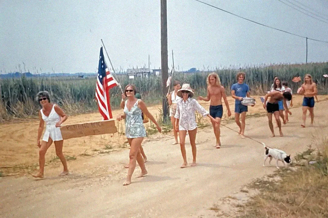3. Barefoot and Beaming, Locals Paraded with Pride Through Pickering Beach in 1976 1. Queen Was on Fire in 1976, Even if the Hairstyles Were Questionable, 2. The Hudson River Lit Up with Boats and Patriotism on the 4th of July, 1976, 3. Barefoot and Beaming, Locals Paraded with Pride Through Pickering Beach in 1976, 4. A Helpful Hand at Kmart's Camera Counter as Film Photography Ruled 1976, 5. A Snapshot of LA Youth in the Summer of '76, 6. Festive Fries and Holiday Cheer at McDonald's in the Heart of the Seventies, 7. Marching to the Beat of Freedom During the 1976 Bicentennial Celebration, 8. A Fall Night on Broadway and 44th in 1976 Manhattan, 9. Candlelit Conversations and Cozy Vibes at a 1976 House Party, 10. This Toddler Had Style to Spare in 1976, 11. Lazy Beach Days and Summer Love in South Shields, 1976, 12. Packed Nights and Rock 'n' Roll Vibes Inside Max's Kansas City, NYC, 1976, 13. Americans Gather Around the Bicentennial "Freedom Train" Carrying Priceless Pieces of History, 14. Teenage Love Caught on Camera in a Quiet New York Room, 1976, 15. Chaos and Cheers at the Battle Royal in L.A.'s Olympic Auditorium, 16. Jodie Foster Stuns at Just 14 in the Gritty Classic Taxi Driver, 1976, 17. The Power of Christ Compels You at Detroit’s Infamous Exorcist Lounge, 1976, 18. Arcade Dreams and Mall Magic Collide at Old Chicago in 1976, 19. School Vaccinations in 1976 Highland Park, 20. Dancing in the Streets of Brooklyn During A Joyful Block Party Moment in 1976, 21. Serving Up Street Flavor Outside the Met on a Summer Day in 1976, 22. A Group of Kids Waits Patiently for the Subway in a Gritty 1976 New York City, 23. Neighborhood Kids Gear Up for Halloween With Their Spookiest Masks in 1976, 24. President Jimmy Carter Casually Hops a Fence at LaGuardia Airport With an Aide, 1976, 25. Dining Above the Clouds at Windows on the World, 1976, 26. David Bowie in 1976, Redefining Cool with Every Glance, 27. AC/DC Rocking Their Way to Global Fame in 1976, 28. A Young Woman Hitchhiking Through Florida's Sun-Soaked Highways in 1976, 29. A Group of Young Concertgoers Soaking Up the Vibes in Ohio, 30. A Surprising Snapshot of Hollywood Charm, 31. When Superheroes Took the Plunge at SeaWorld's Wild 1976 Show, 32. Charlie's Angels Redefined Cool and Confidence in 1976, 33. Kiss Turns Heads While Strutting Through NYC in Full Costume, 1976