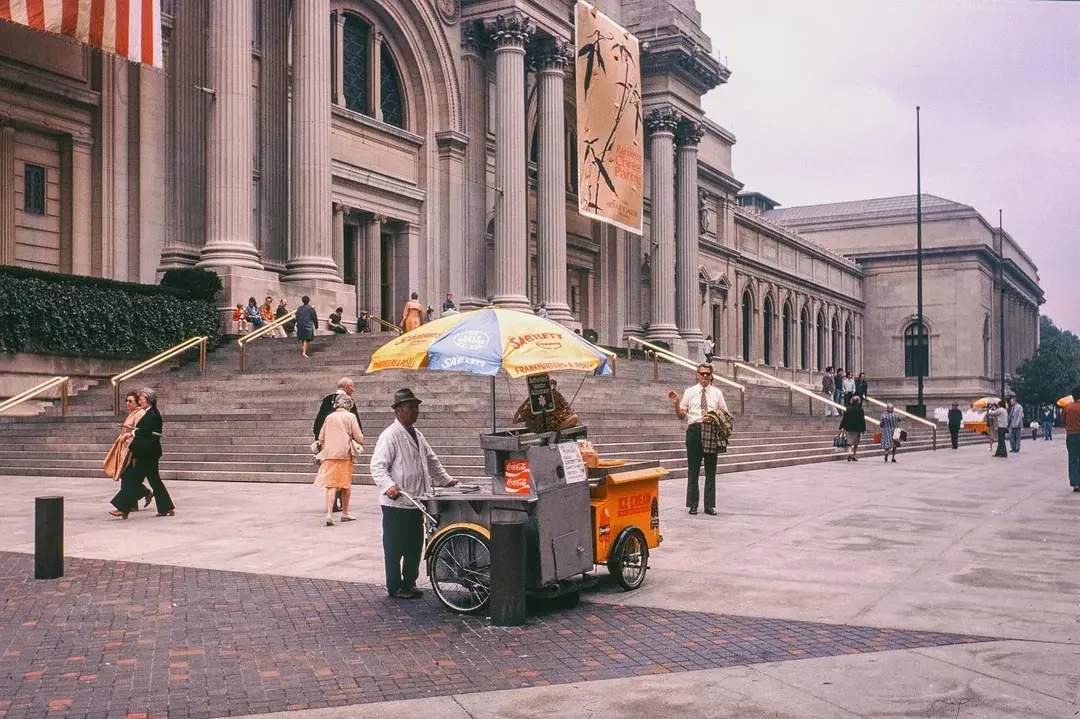 22. Serving Up Street Flavor Outside the Met on a Summer Day in 1976 1. Queen Was on Fire in 1976, Even if the Hairstyles Were Questionable, 2. The Hudson River Lit Up with Boats and Patriotism on the 4th of July, 1976, 3. Barefoot and Beaming, Locals Paraded with Pride Through Pickering Beach in 1976, 4. A Helpful Hand at Kmart's Camera Counter as Film Photography Ruled 1976, 5. A Snapshot of LA Youth in the Summer of '76, 6. Festive Fries and Holiday Cheer at McDonald's in the Heart of the Seventies, 7. Marching to the Beat of Freedom During the 1976 Bicentennial Celebration, 8. A Fall Night on Broadway and 44th in 1976 Manhattan, 9. Candlelit Conversations and Cozy Vibes at a 1976 House Party, 10. This Toddler Had Style to Spare in 1976, 11. Lazy Beach Days and Summer Love in South Shields, 1976, 12. Packed Nights and Rock 'n' Roll Vibes Inside Max's Kansas City, NYC, 1976, 13. Americans Gather Around the Bicentennial "Freedom Train" Carrying Priceless Pieces of History, 14. Teenage Love Caught on Camera in a Quiet New York Room, 1976, 15. Chaos and Cheers at the Battle Royal in L.A.'s Olympic Auditorium, 16. Jodie Foster Stuns at Just 14 in the Gritty Classic Taxi Driver, 1976, 17. The Power of Christ Compels You at Detroit’s Infamous Exorcist Lounge, 1976, 18. Arcade Dreams and Mall Magic Collide at Old Chicago in 1976, 19. School Vaccinations in 1976 Highland Park, 20. Dancing in the Streets of Brooklyn During A Joyful Block Party Moment in 1976, 21. Serving Up Street Flavor Outside the Met on a Summer Day in 1976, 22. A Group of Kids Waits Patiently for the Subway in a Gritty 1976 New York City, 23. Neighborhood Kids Gear Up for Halloween With Their Spookiest Masks in 1976, 24. President Jimmy Carter Casually Hops a Fence at LaGuardia Airport With an Aide, 1976, 25. Dining Above the Clouds at Windows on the World, 1976, 26. David Bowie in 1976, Redefining Cool with Every Glance, 27. AC/DC Rocking Their Way to Global Fame in 1976, 28. A Young Woman Hitchhiking Through Florida's Sun-Soaked Highways in 1976, 29. A Group of Young Concertgoers Soaking Up the Vibes in Ohio, 30. A Surprising Snapshot of Hollywood Charm, 31. When Superheroes Took the Plunge at SeaWorld's Wild 1976 Show, 32. Charlie's Angels Redefined Cool and Confidence in 1976, 33. Kiss Turns Heads While Strutting Through NYC in Full Costume, 1976