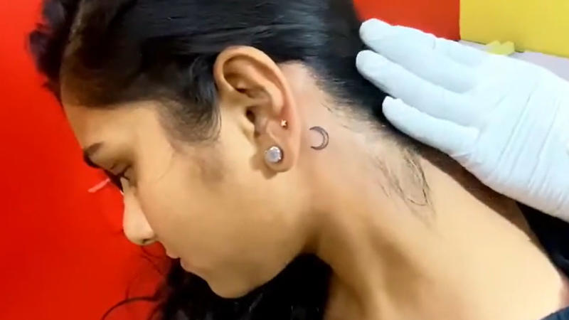 1. Dainty Butterfly On Collarbone, 2. Tiny Heart Outline On Wrist, 3. Mini Moon Behind The Ear, 4. Feather On Inner Forearm, 5. Tiny Rose On Finger, 6. Single Star On Ankle, 7. Mini Crown On Nape, 8. Cherry Blossom On Ribcage, 9. Tiny Paw Print On Foot, 10. Dandelion With Blowing Seeds, 11. Angel Wings On The Back Of The Arm, 12. Tiny Script Word On Collarbone, 13. Tiny Rainbow On Wrist, 14. Wine Glass On Hip, 15. Anchor On Side Rib, 16. Music Note Behind The Ear, 17. Lavender Sprig On Arm, 18. Infinity Symbol With Initials, 19. Tiny Mushroom Cluster On Ankle, 20. Cupcake With Cherry On Top On Hip