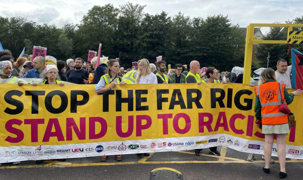Pictured: Anti-migrant protesters gather outside Britannia Hotel in Canary Wharf, Pictured: Anti-migrant protesters gather outside Bell Hotel in Epping, Protesters and counter-demonstrators gather in Epping, Pictured: Stand Up To Racism crowd grows ahead of Epping protest, Canary Wharf locals protest use of Britannia hotel for migrants, Two men charged with public order offence after Diss hotel protest, Pictured: Police gather in Epping ahead of migrant hotel protests, Poll reveals British view on small boat crossings, Residents feel 'trapped' as harassment fears grow around migrant hotel protests, Nigel Farage apologises after false Epping protest claim, Elite police division monitoring social media to prevent Epping unrest, What caused the Epping anti-migration protests?, Essex police announces plan for Epping protests, Protests organised by members of Neo-Nazi groups, Police announce new protest restrictions to tackle unrest, Asylum seekers afraid to leave hotel amid protests