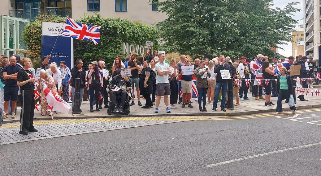 Pictured: Anti-migrant protesters gather outside Britannia Hotel in Canary Wharf, Pictured: Anti-migrant protesters gather outside Bell Hotel in Epping, Protesters and counter-demonstrators gather in Epping, Pictured: Stand Up To Racism crowd grows ahead of Epping protest, Canary Wharf locals protest use of Britannia hotel for migrants, Two men charged with public order offence after Diss hotel protest, Pictured: Police gather in Epping ahead of migrant hotel protests, Poll reveals British view on small boat crossings, Residents feel 'trapped' as harassment fears grow around migrant hotel protests, Nigel Farage apologises after false Epping protest claim, Elite police division monitoring social media to prevent Epping unrest, What caused the Epping anti-migration protests?, Essex police announces plan for Epping protests, Protests organised by members of Neo-Nazi groups, Police announce new protest restrictions to tackle unrest, Asylum seekers afraid to leave hotel amid protests