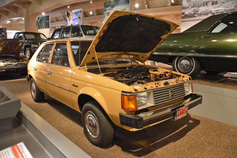 Dodge Omni (1978) Roper steam carriage (1865), Ford 999 (1902), Holsman Runabout (1903), Scripps-Booth Rocket (1913), Detroit-Electric Model 47 (1914), Brewster Town Landaulet (1915), Chevrolet Royal Mail (1915), Woods Dual-Power (1916), Chrysler B-70 (1924), Essex Coach (1924), Ford Flivver (1926), Blue Bird school bus (1927), Lincoln Zephyr (1936), Lincoln Bubbletop (1950), Crosley Hotshot (1951), Chrysler 300-B (1956), Cornell-Liberty Safety Car (1957), Ford Mustang I concept (1962), Buick Riviera (1963), Chrysler turbine car (1963), Ford Mustang (1965), Toyota Corona (1966), Ford Mark IV (1967), Mercury Cougar (1968), Lincoln presidential limousine (1972), Chrysler Newport (1973), Dodge Omni (1978), Comuta-Car (1980), Ford Escort (1981), Plymouth Voyager (1984), Ford Taurus (1986), General Motors EV1 (1997), Toyota Prius (1997), Ford Focus Electric (2009)